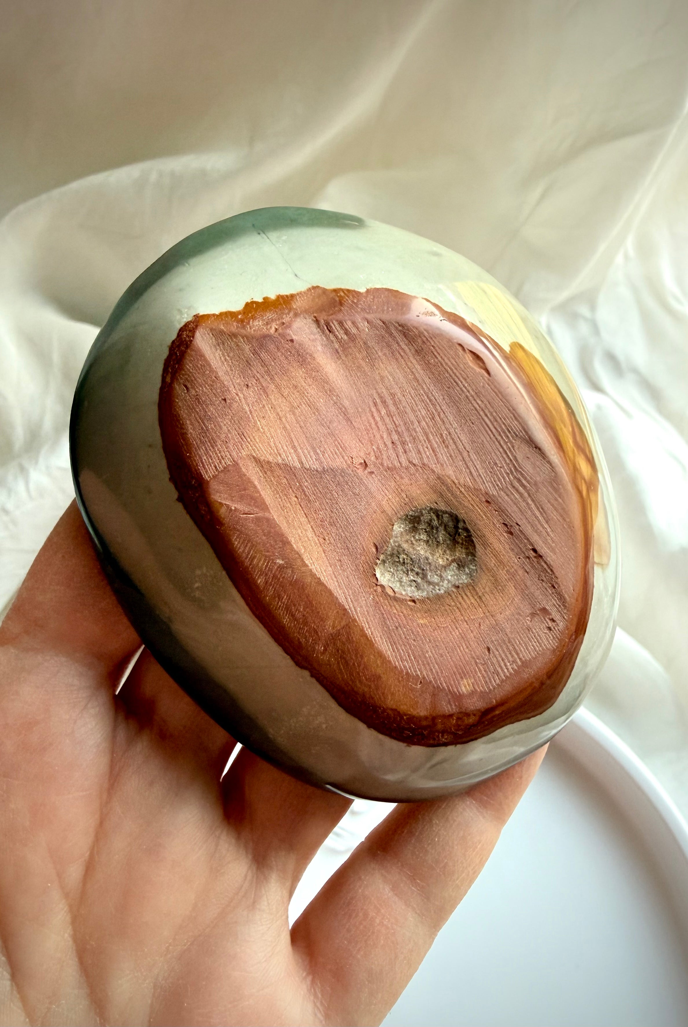 polychrome jasper bowl underside showing natural stone base and carving details