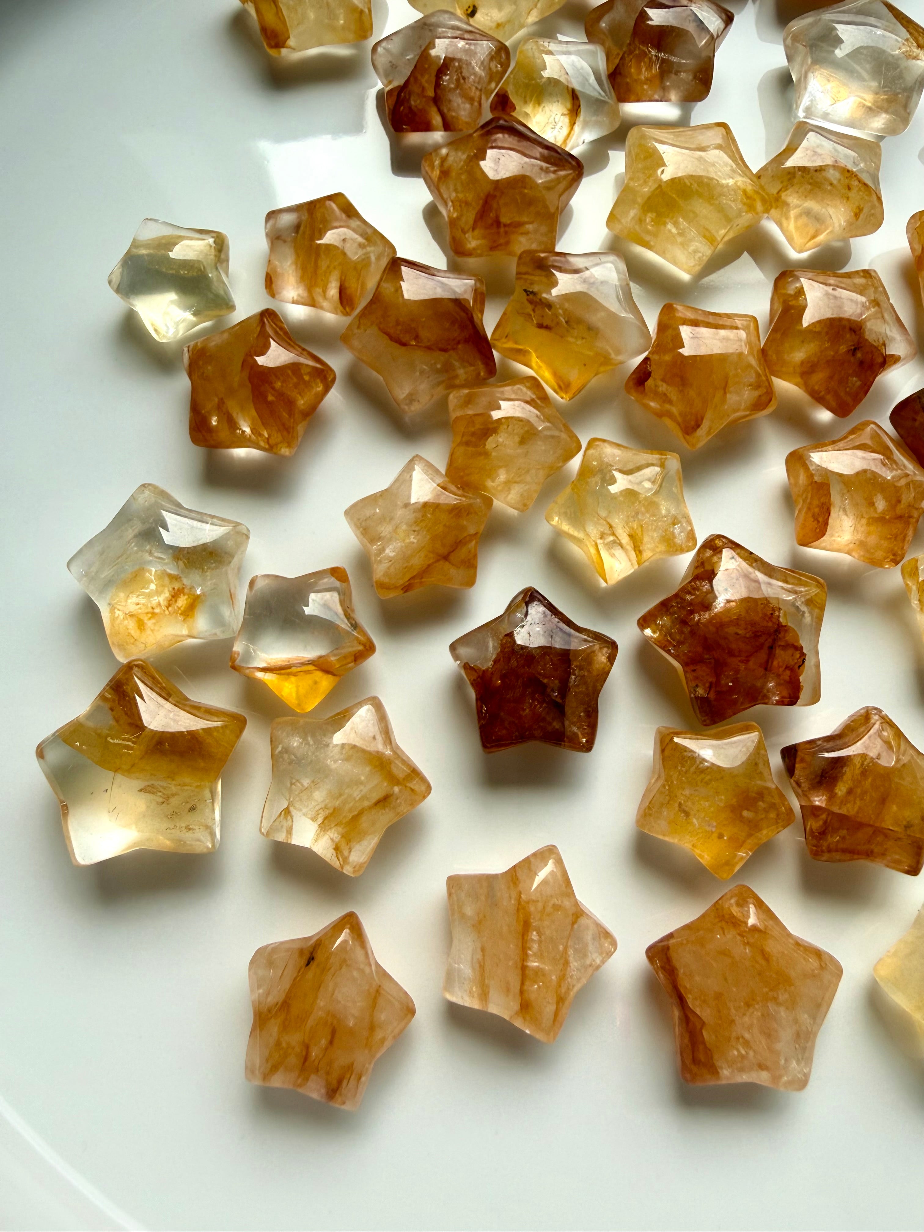 Golden Healer Quartz star carving collection showing unique patterns, clarity, and golden Hematoid inclusions