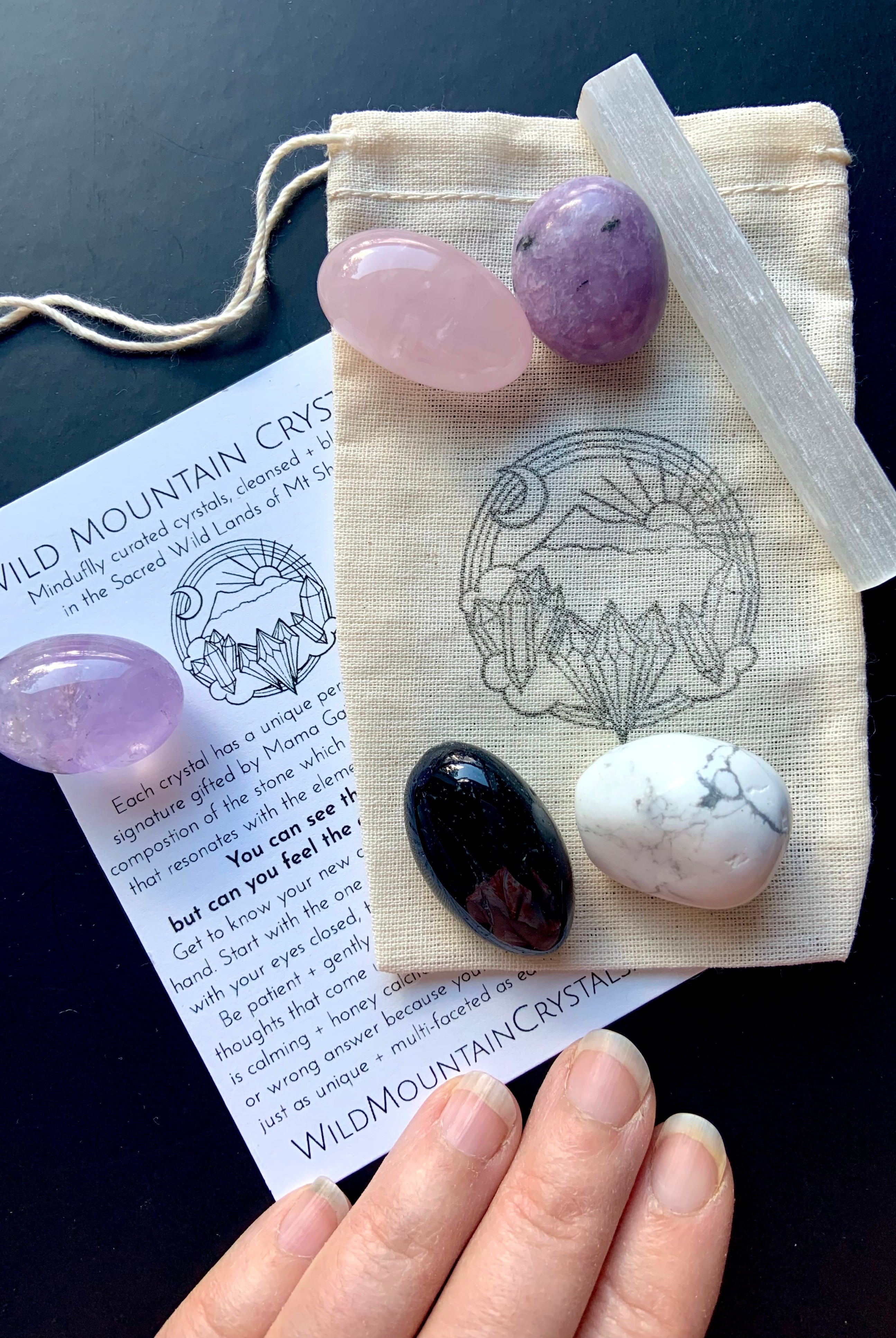 Sweet Sleep Crystal Set of 6 healing stones shown on a cotton pouch with Wild Mountain Crystal logo