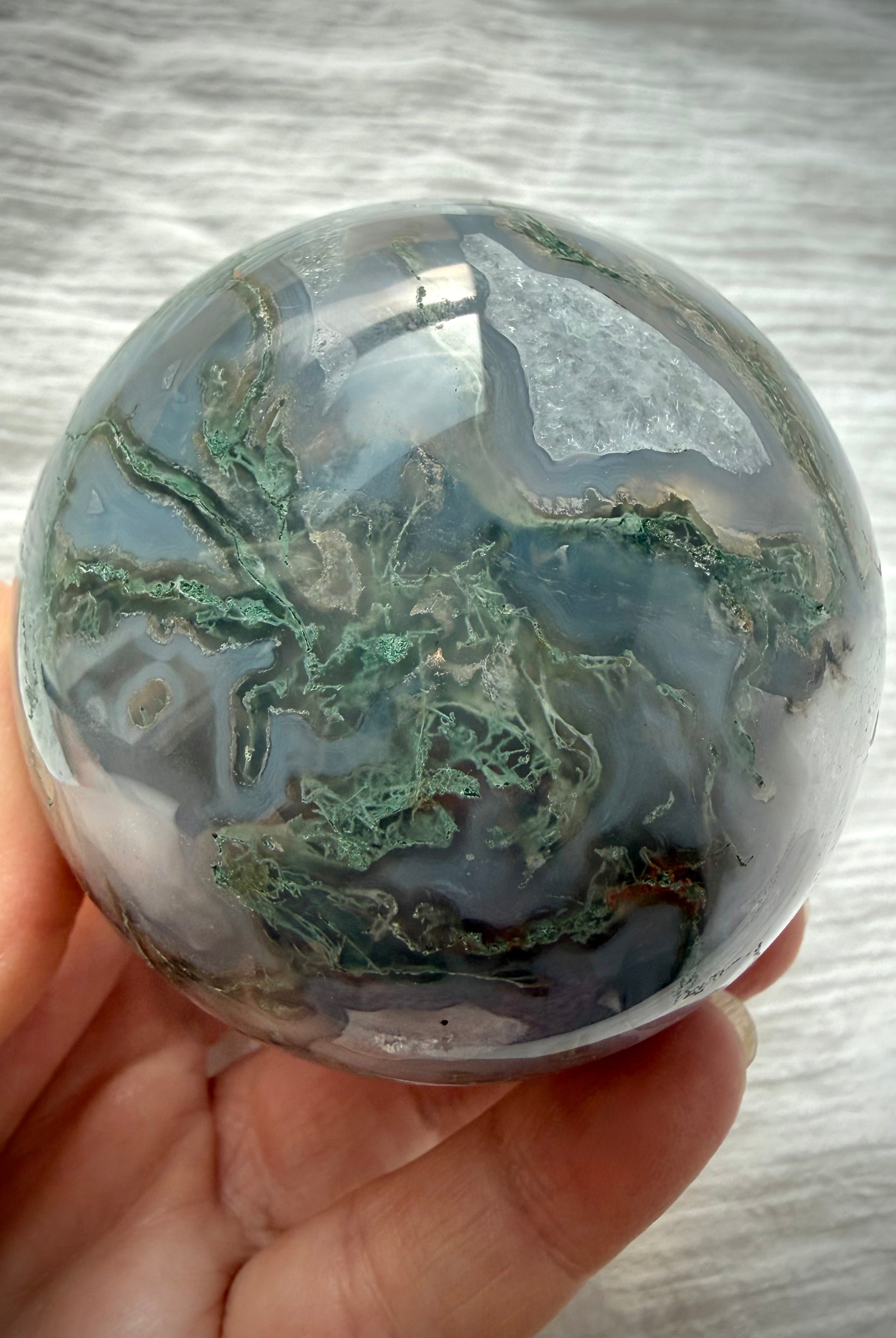 Moss Agate sphere with intricate green dendritic patterns, translucent gray chalcedony and natural Quartz crystal formations