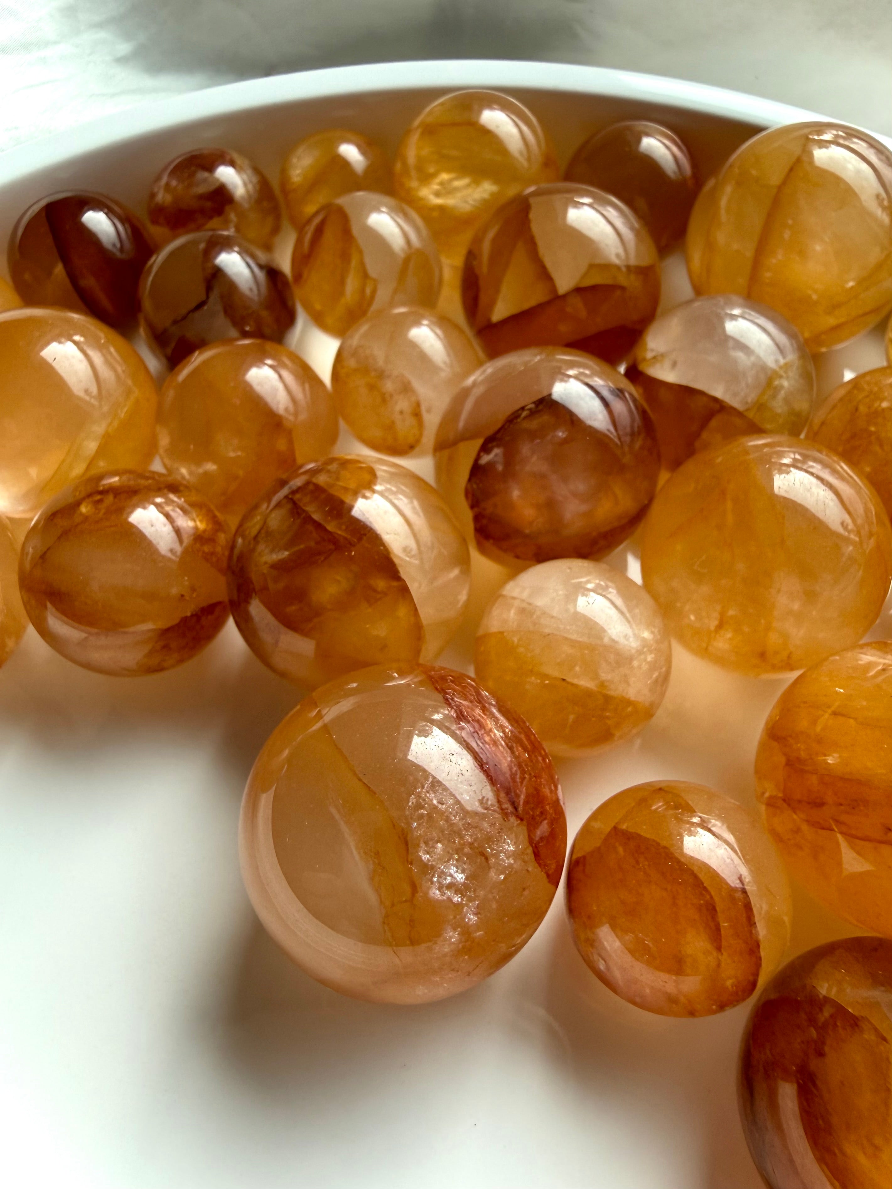 mini golden healer quartz crystal balls in various sizes with warm honey and amber hues