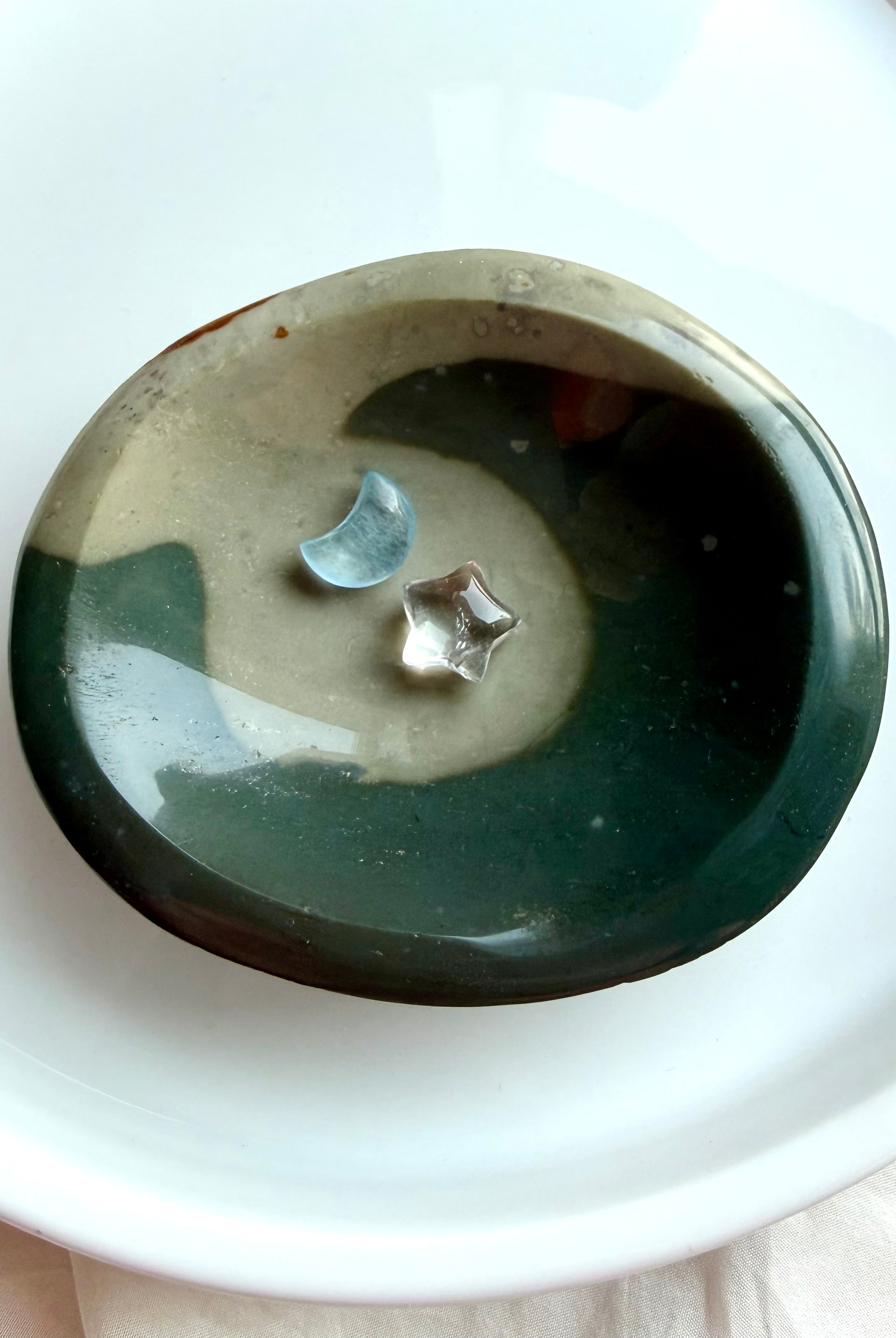shallow polychrome jasper crystal bowl with flowing teal wave pattern and earthy tones