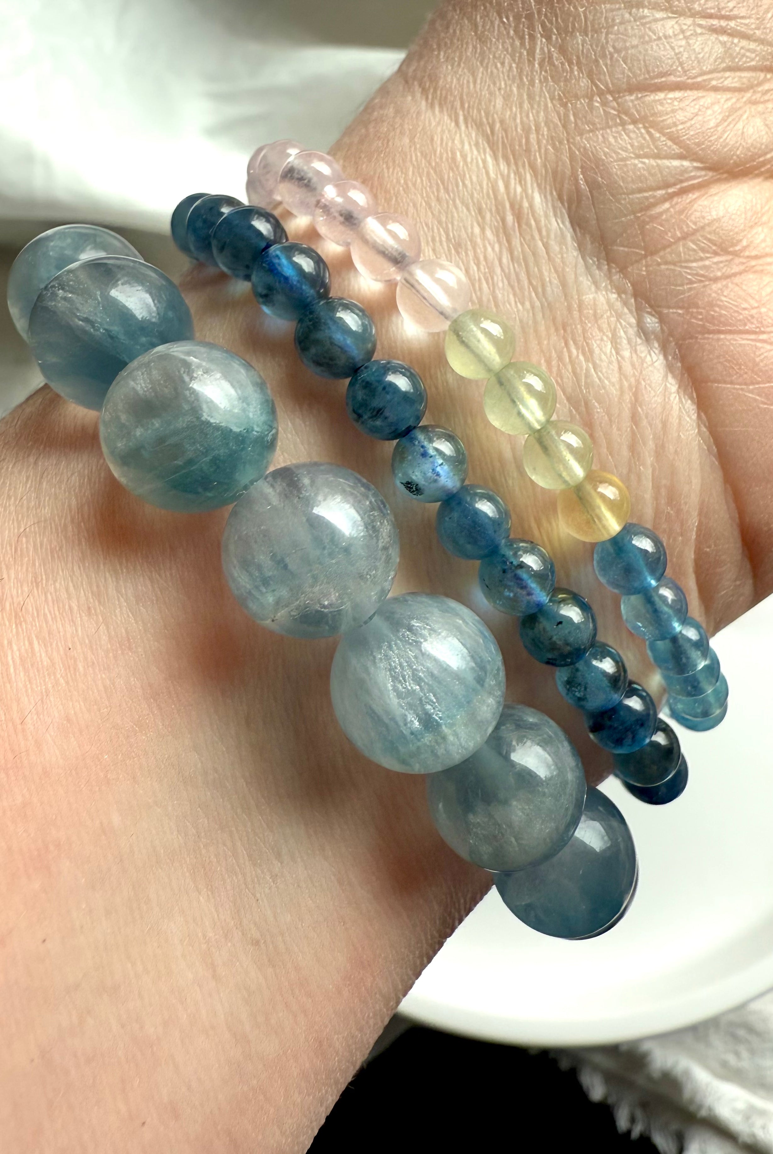 High quality morganite bracelets worn with an aquamarine bracelet + a silky blue fluorite bracelet