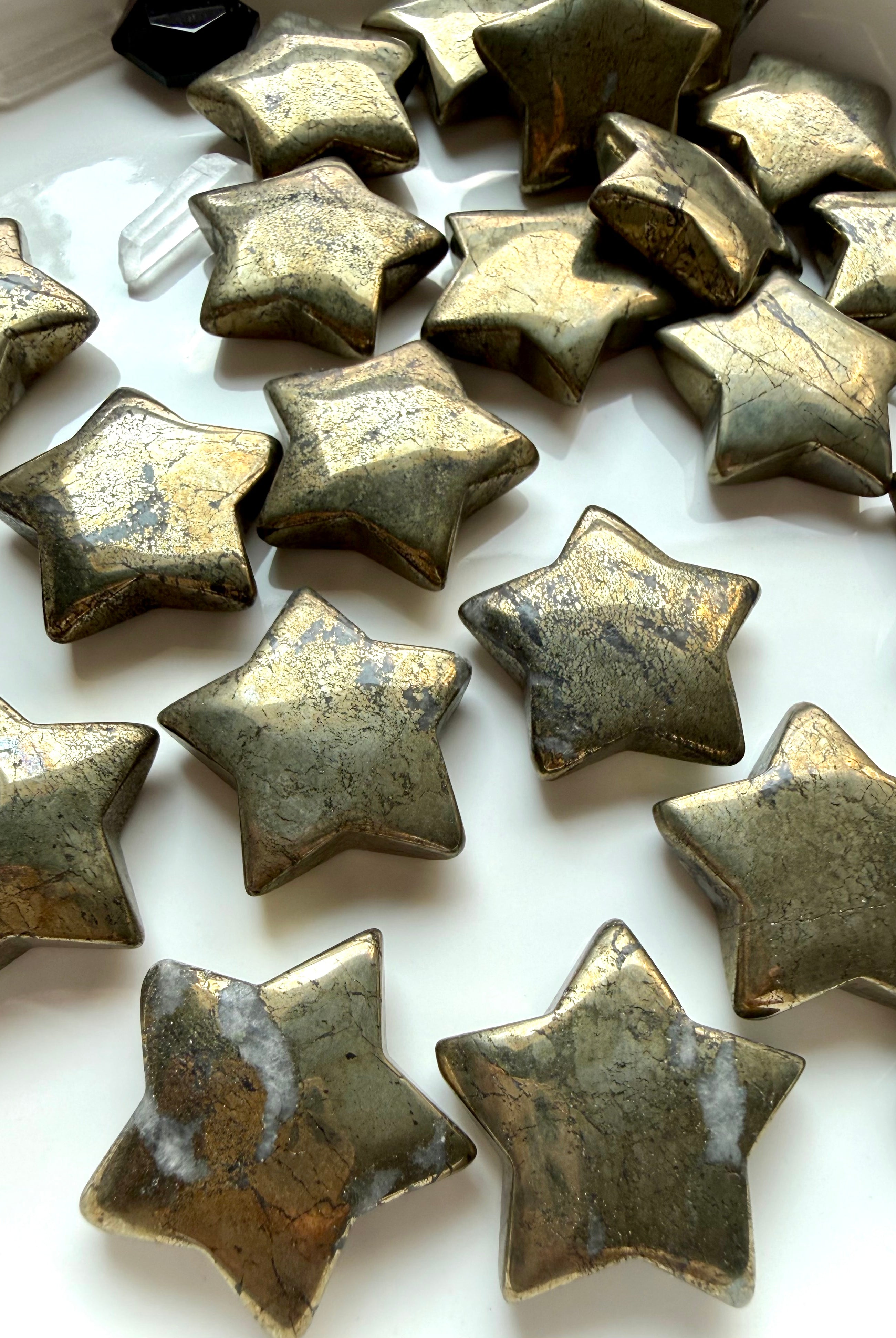 Golden Pyrite star carvings arranged together showing natural metallic luster and unique surface patterns