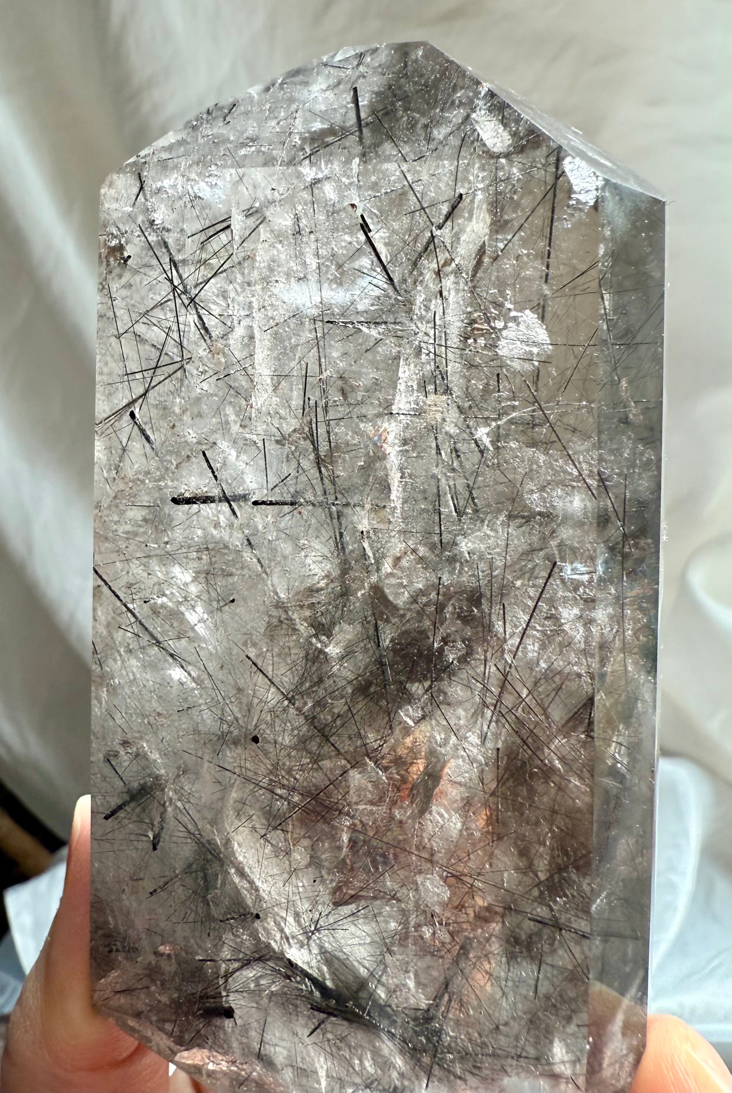 Large polished crystal freeform with Black Tourmaline needles, blades, and dimensional inner landscapes