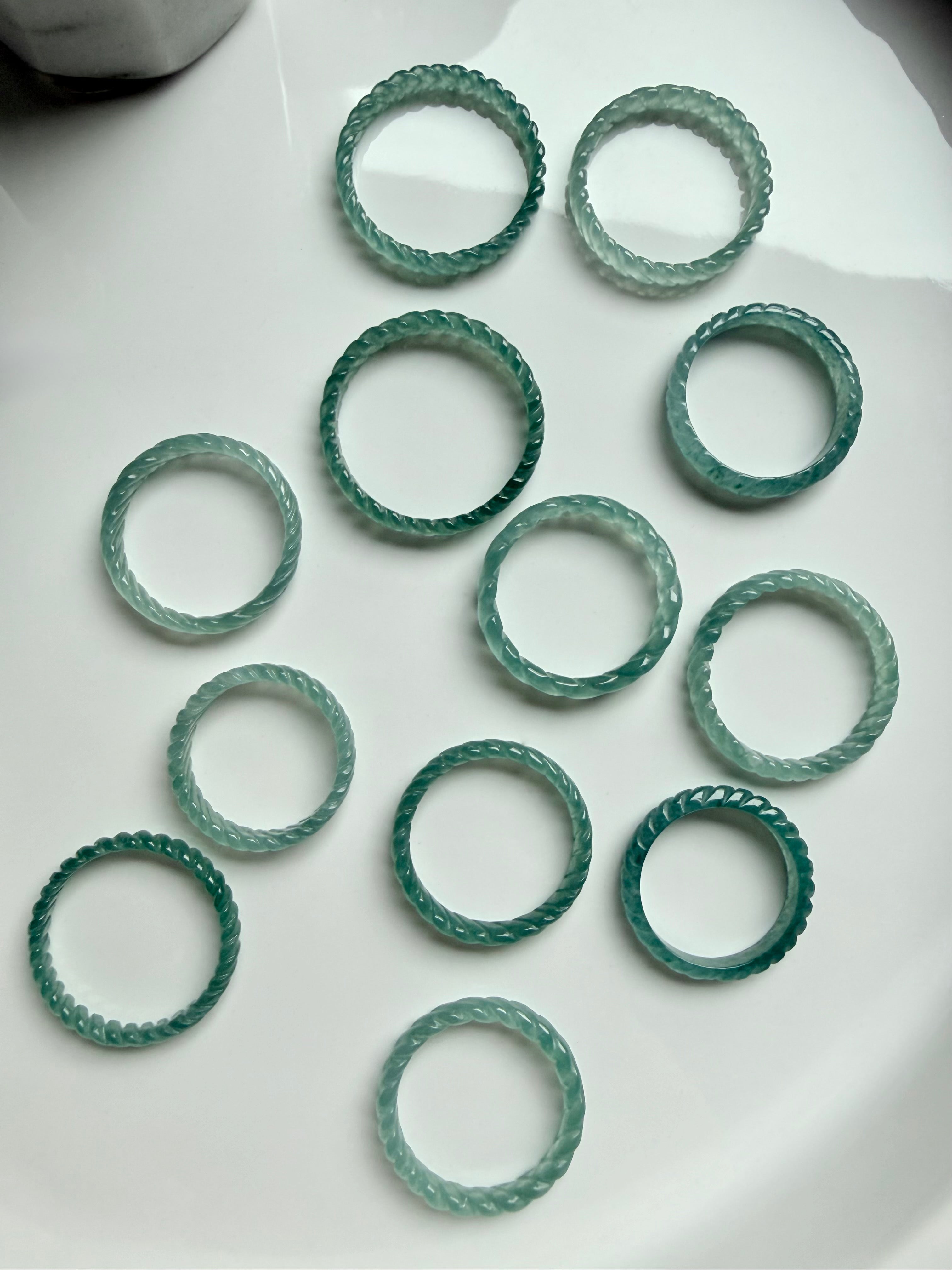 Natural Guatemalan Blue Water Jade woven rings arranged in circle, premium jadeite bands with luminous teal glow