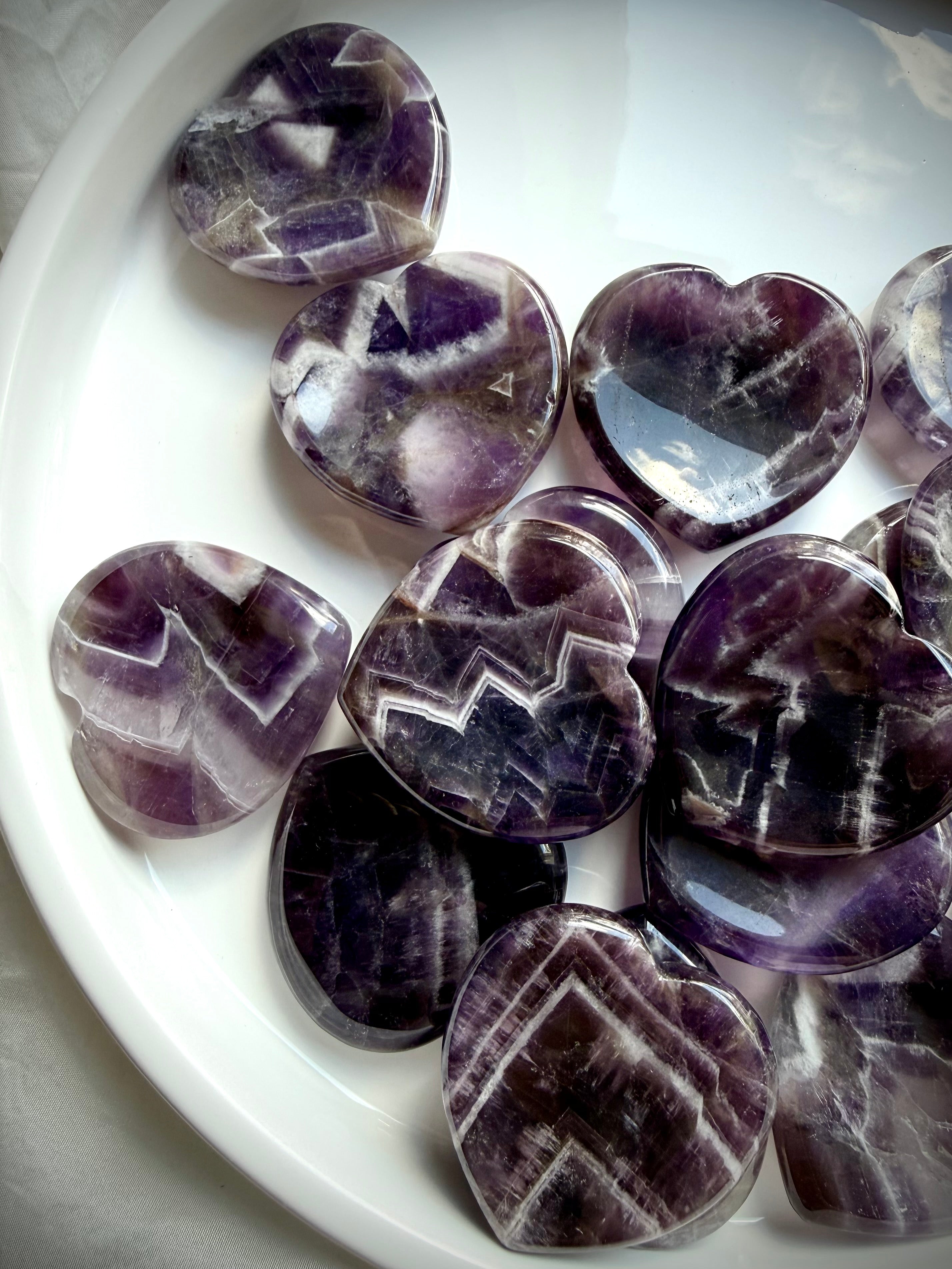 dream amethyst heart worry stones close up showing natural chevron patterns and polish