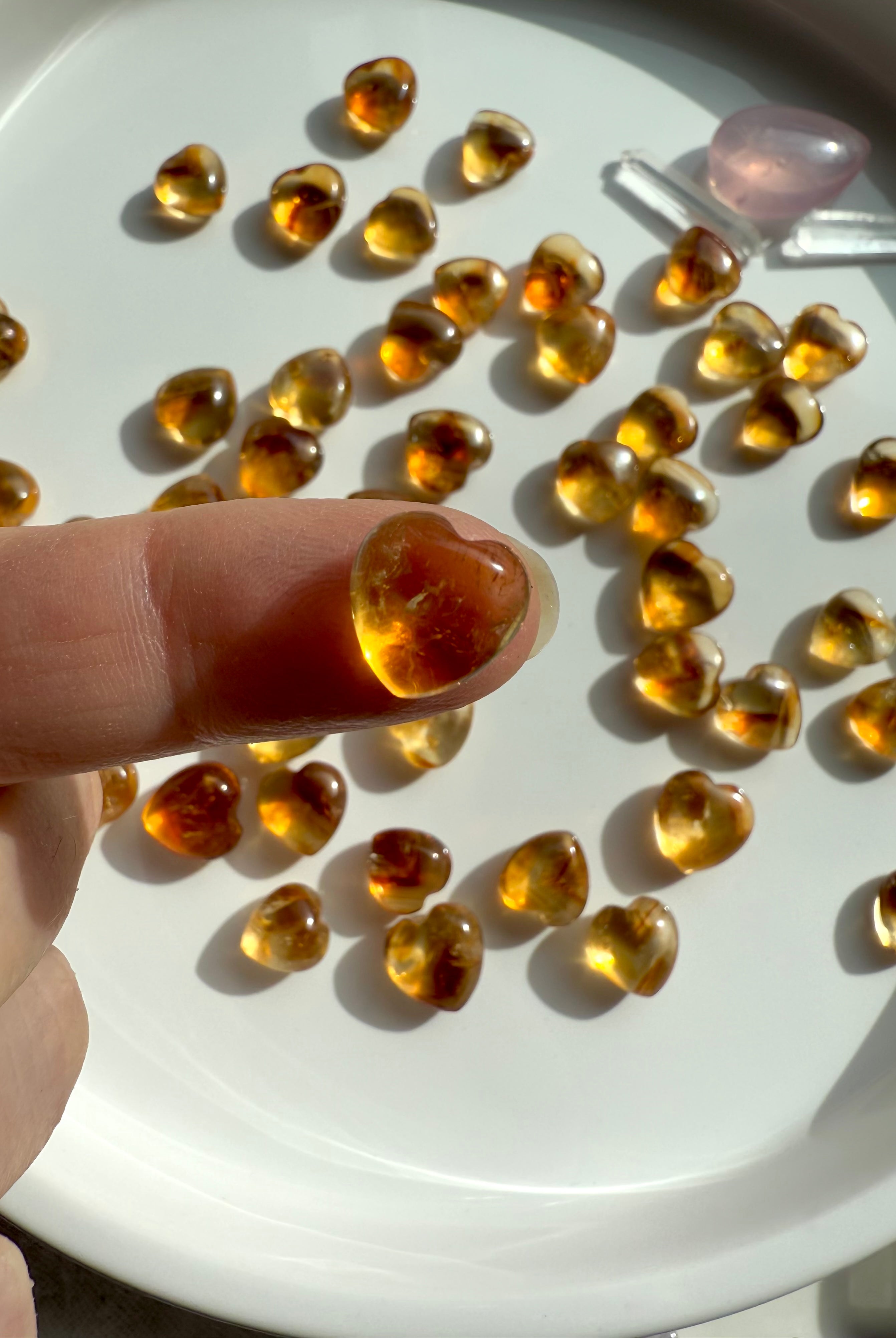 A Mini Citrine Heart shown on my fingertip for scale