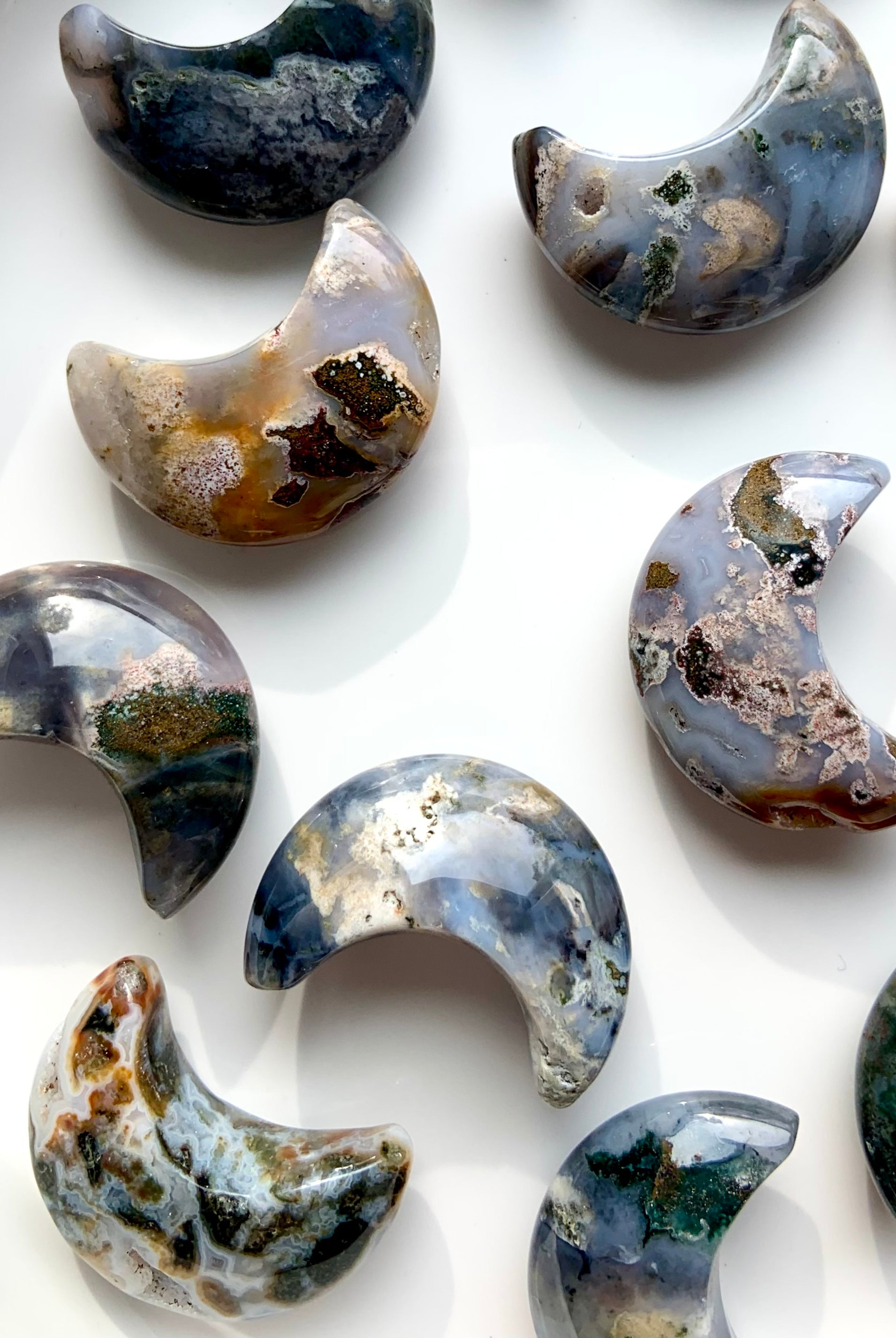 Macro closeup of Cosmic Ocean Jasper moon carvings with natural patterns