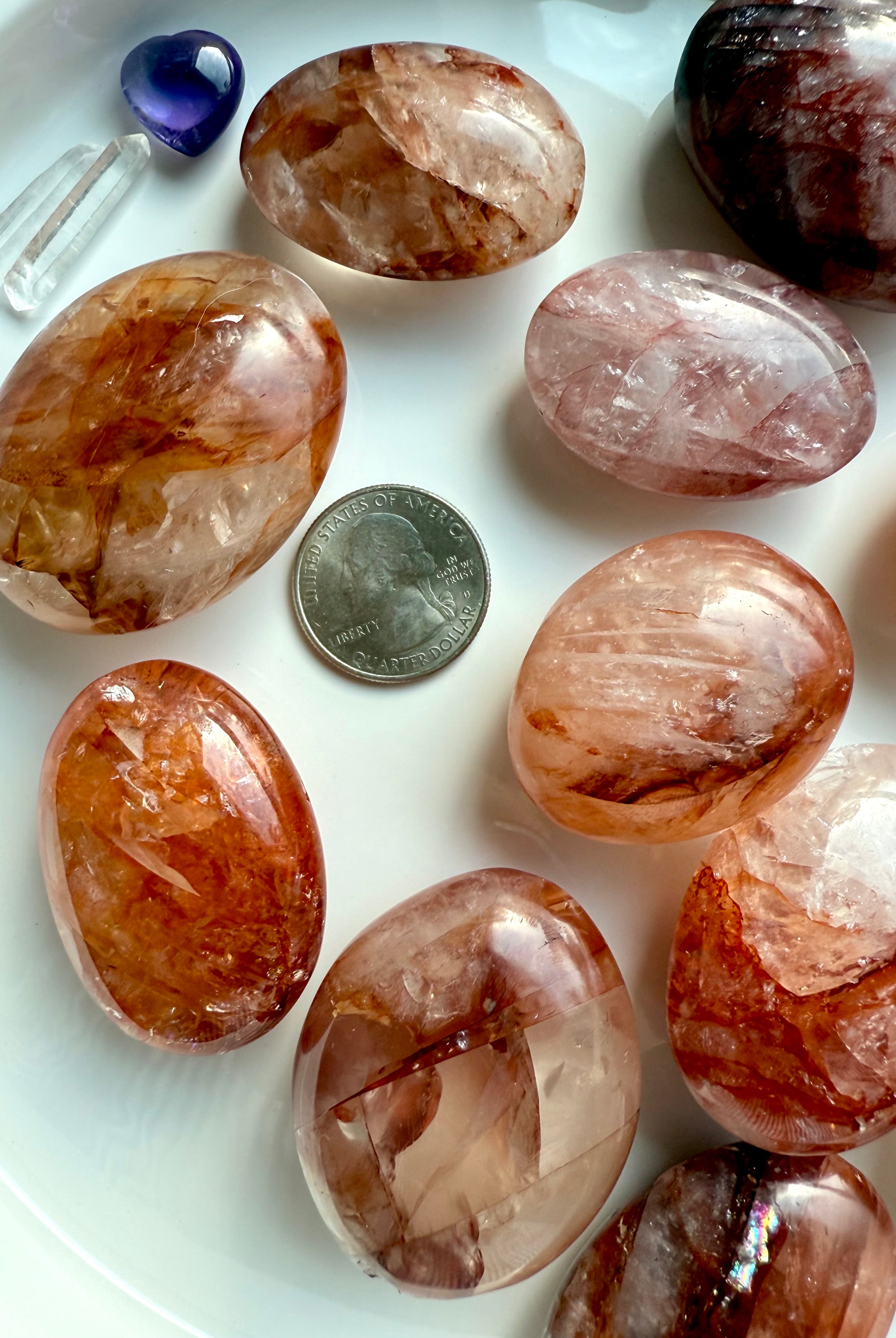 Fire Quartz palm stones with quarter for size reference, styled with crystals for healing energy work