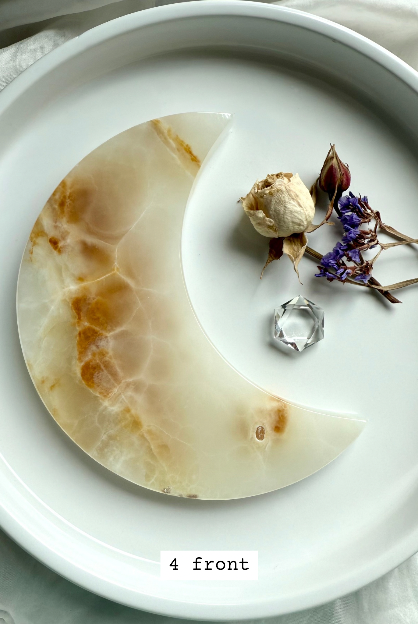 White Onyx Crescent Moon Plate, translucent white with golden tones and banding, front view.