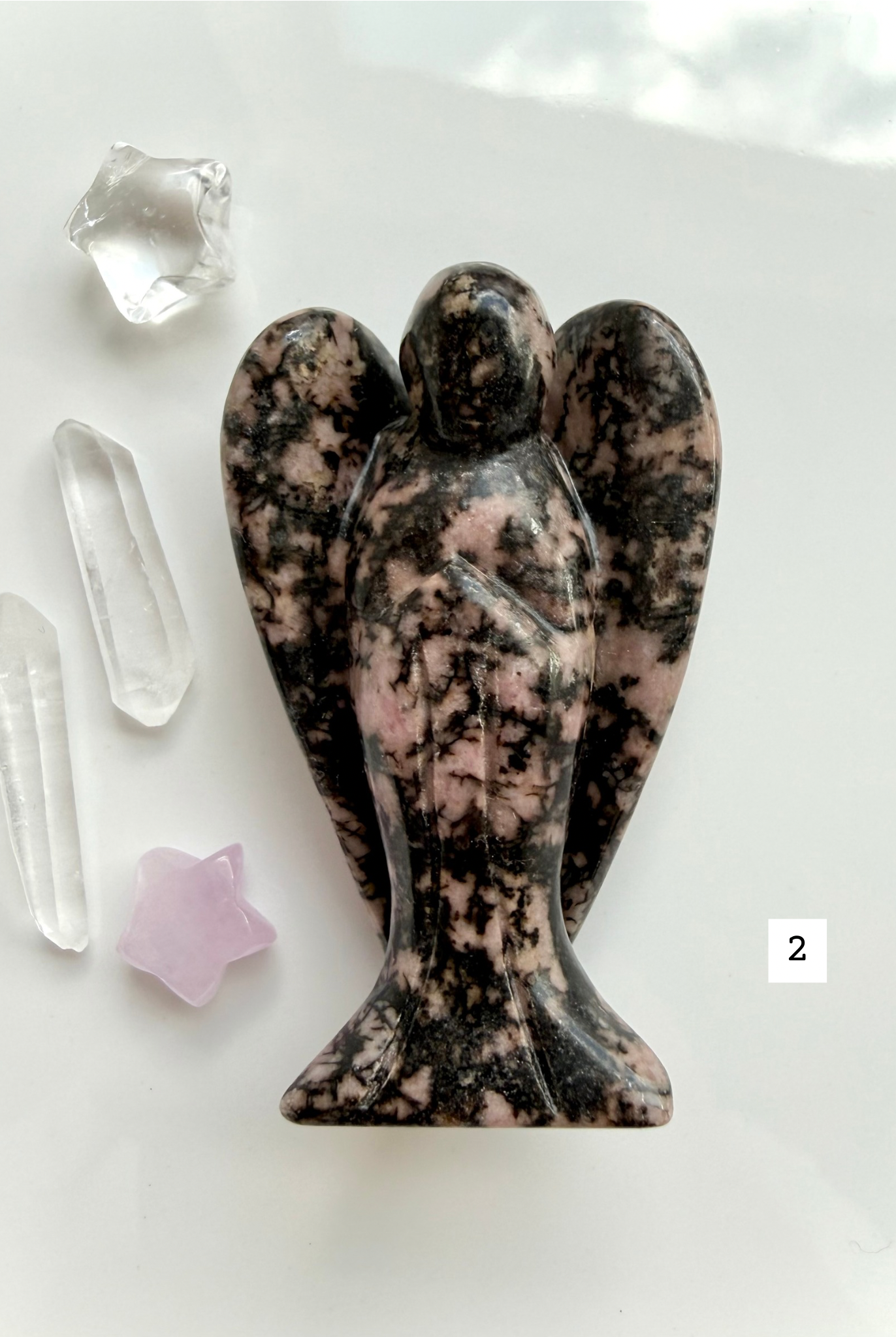 Pink Rhodonite crystal guardian with dark matrix and soothing heart chakra energy