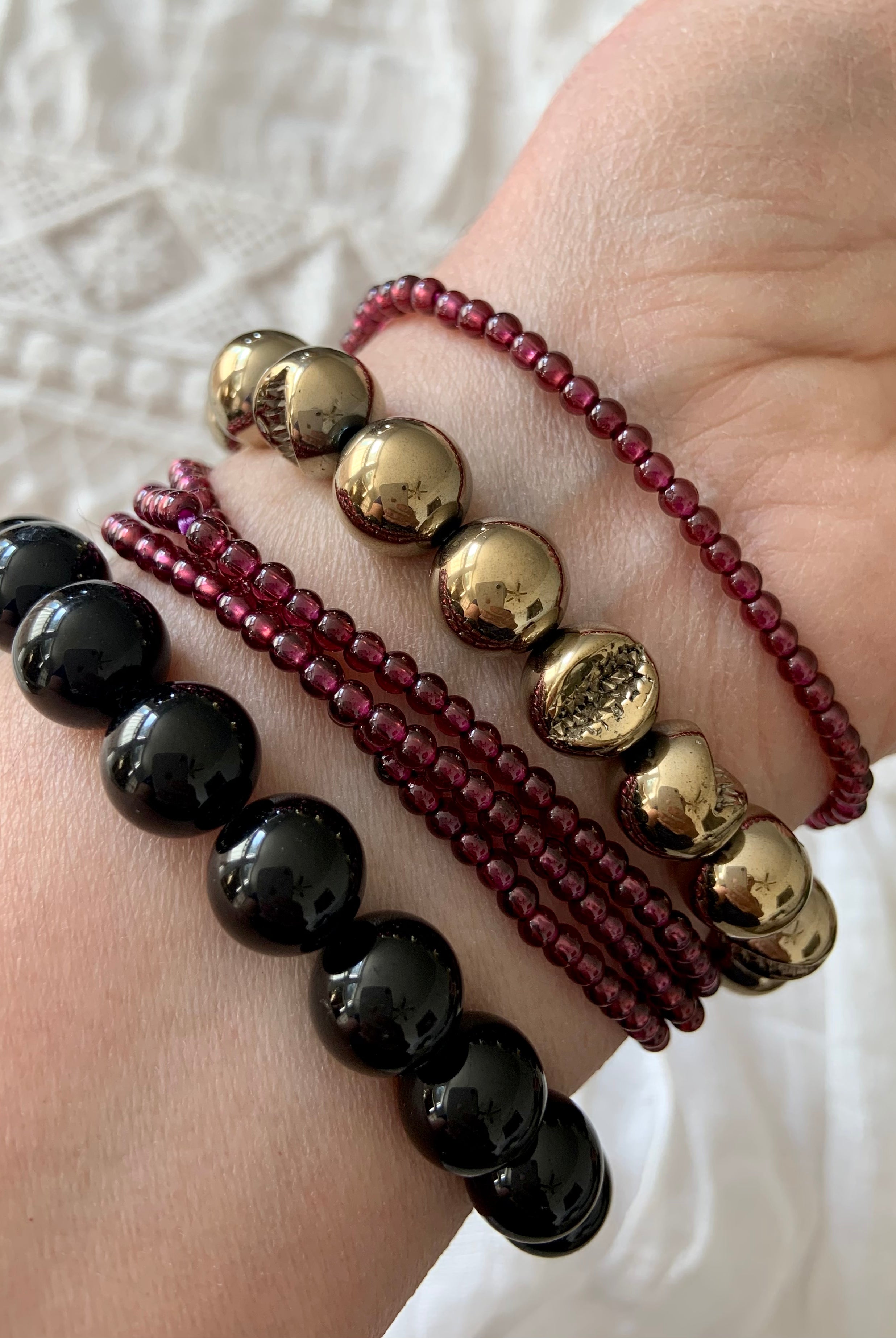 Black Tourmaline bracelet worn with Pyrite and Garnet bracelets — powerful crystal stack for protection, grounding & abundance