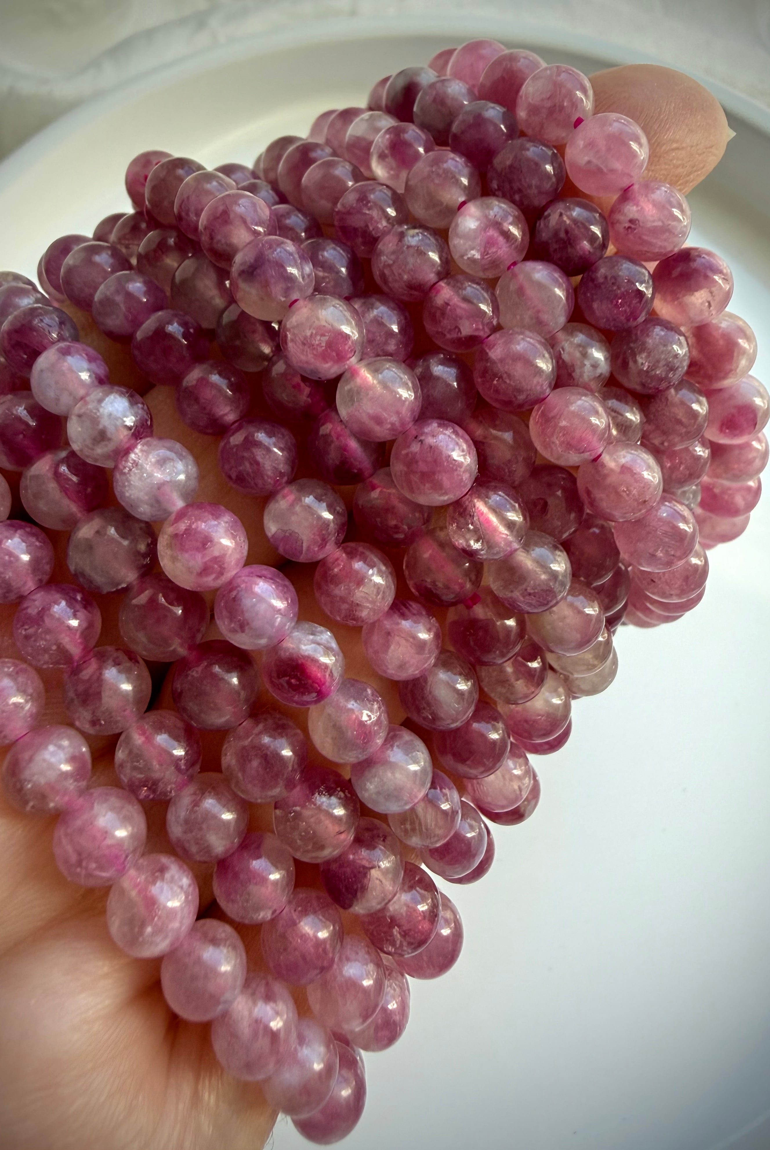Pink Tourmaline bracelet layered on wrist, showcasing romantic pink gemstone jewelry for October birthstone gifts