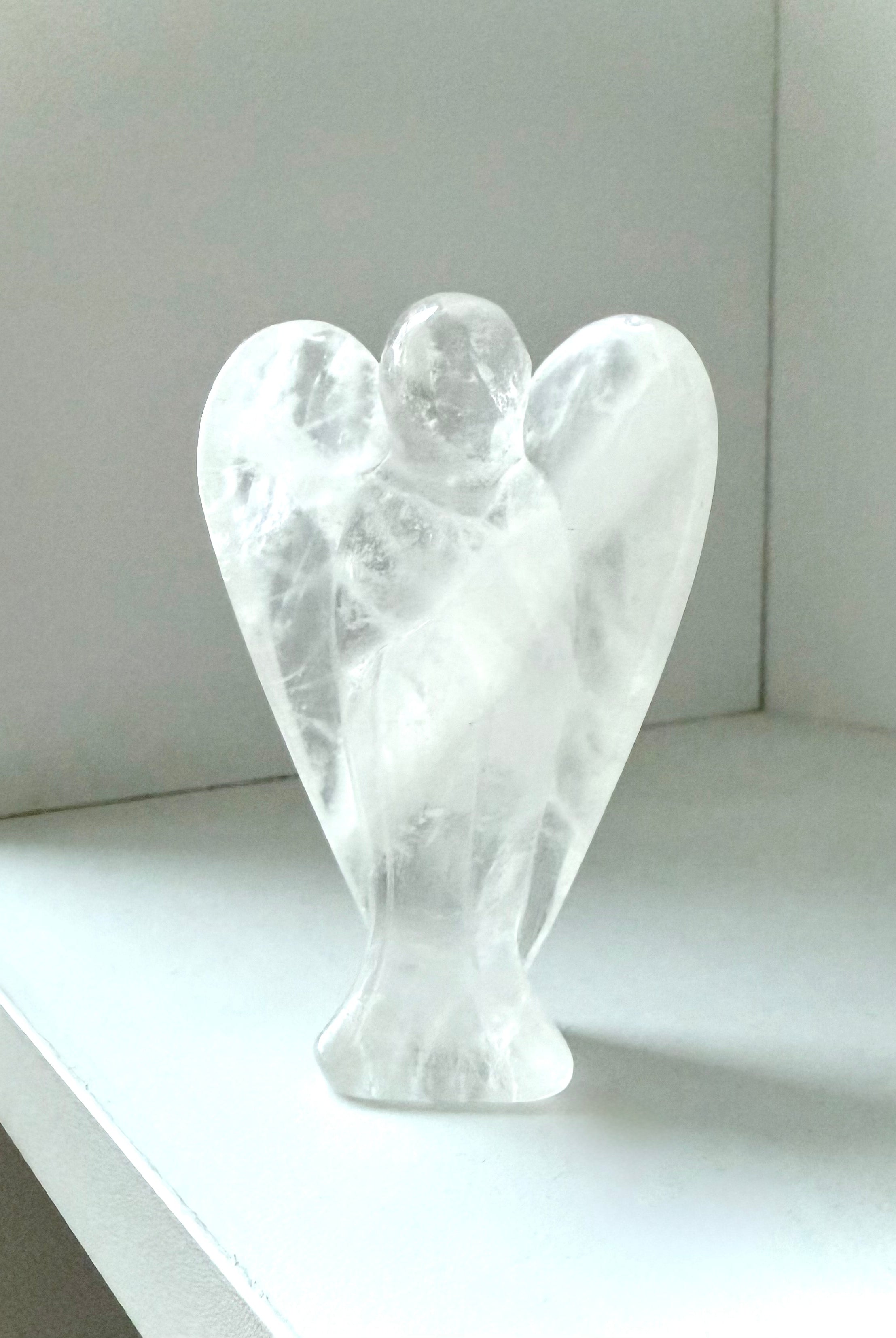 This Clear Quartz Crystal Angel Figurine easily fits in with any style of decor or color scheme