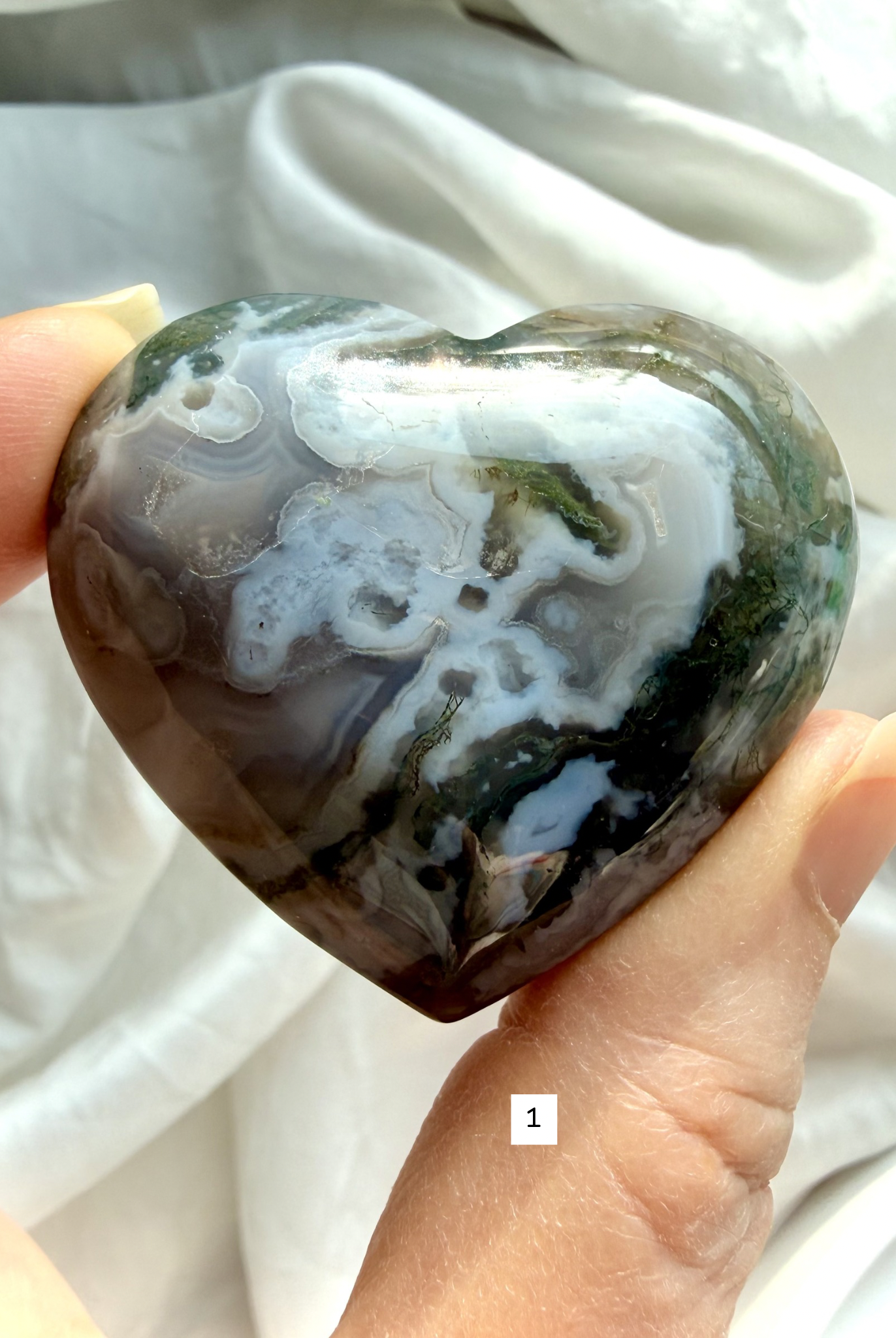 moss agate heart carving option 1 in hand with green moss inclusions and natural chalcedony pattern
