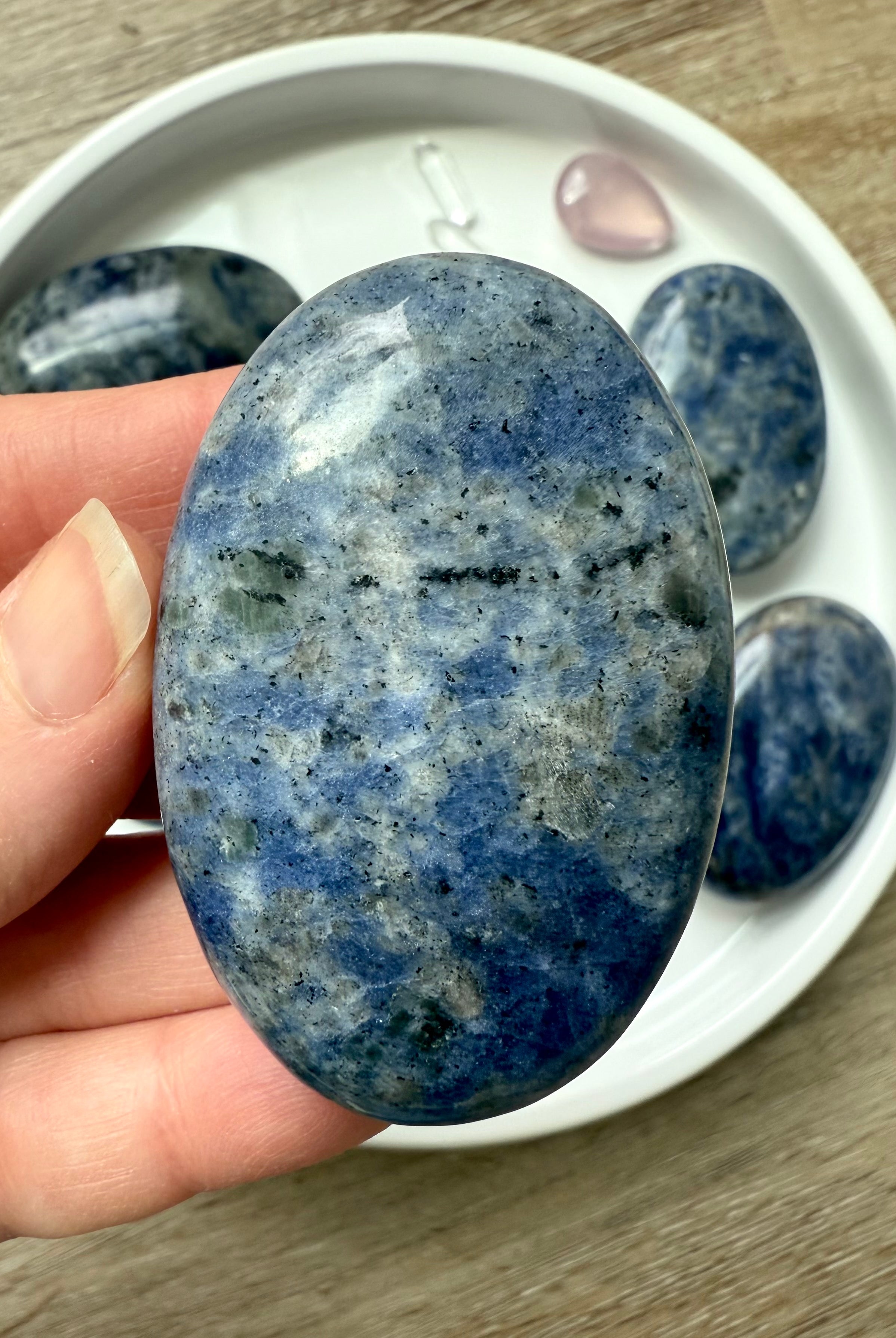 Close up picture of a high quality blue Sodalite Palm Stone held in my hand for scale