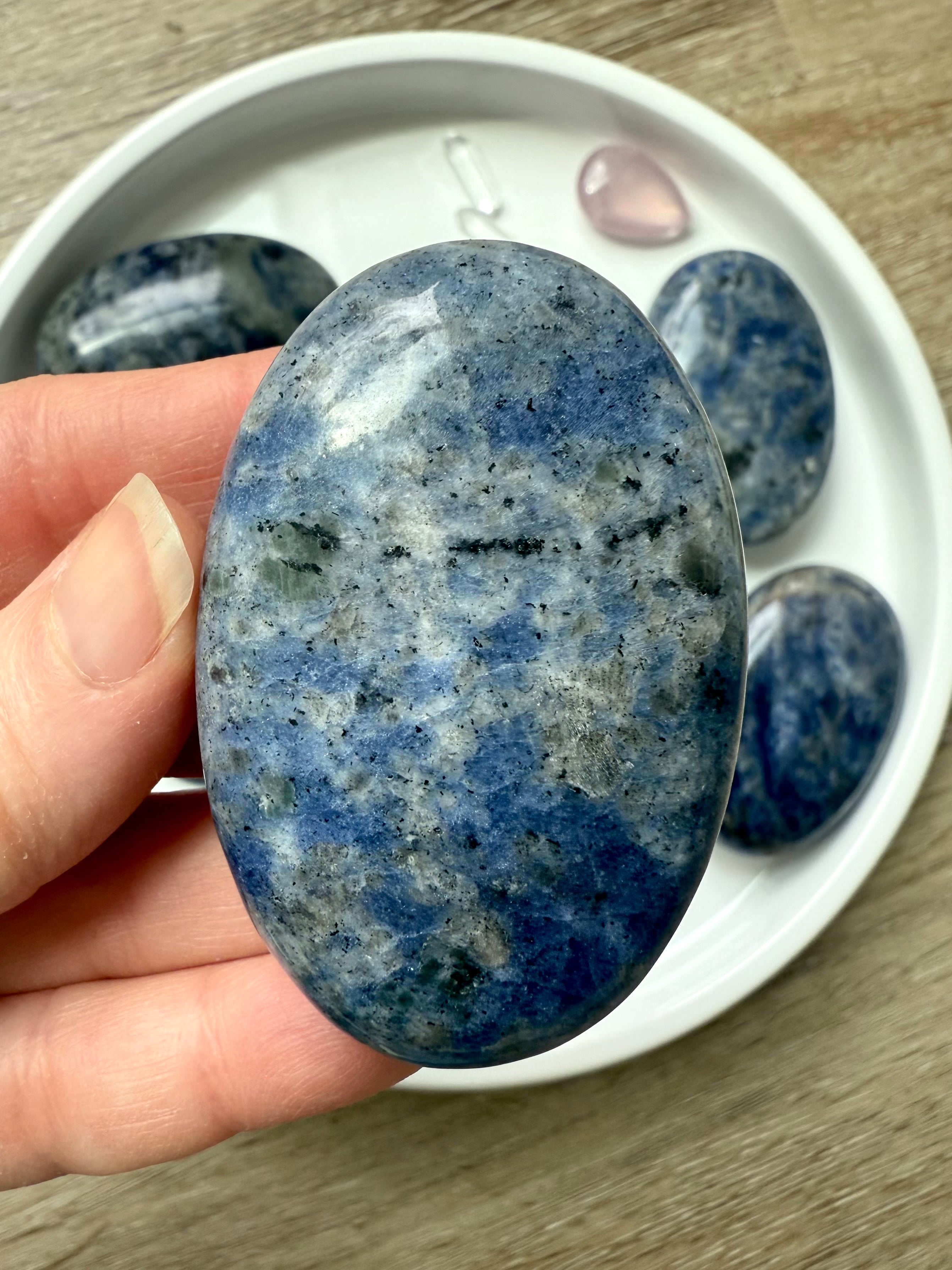 Close up picture of a high quality blue Sodalite Palm Stone held in my hand for scale