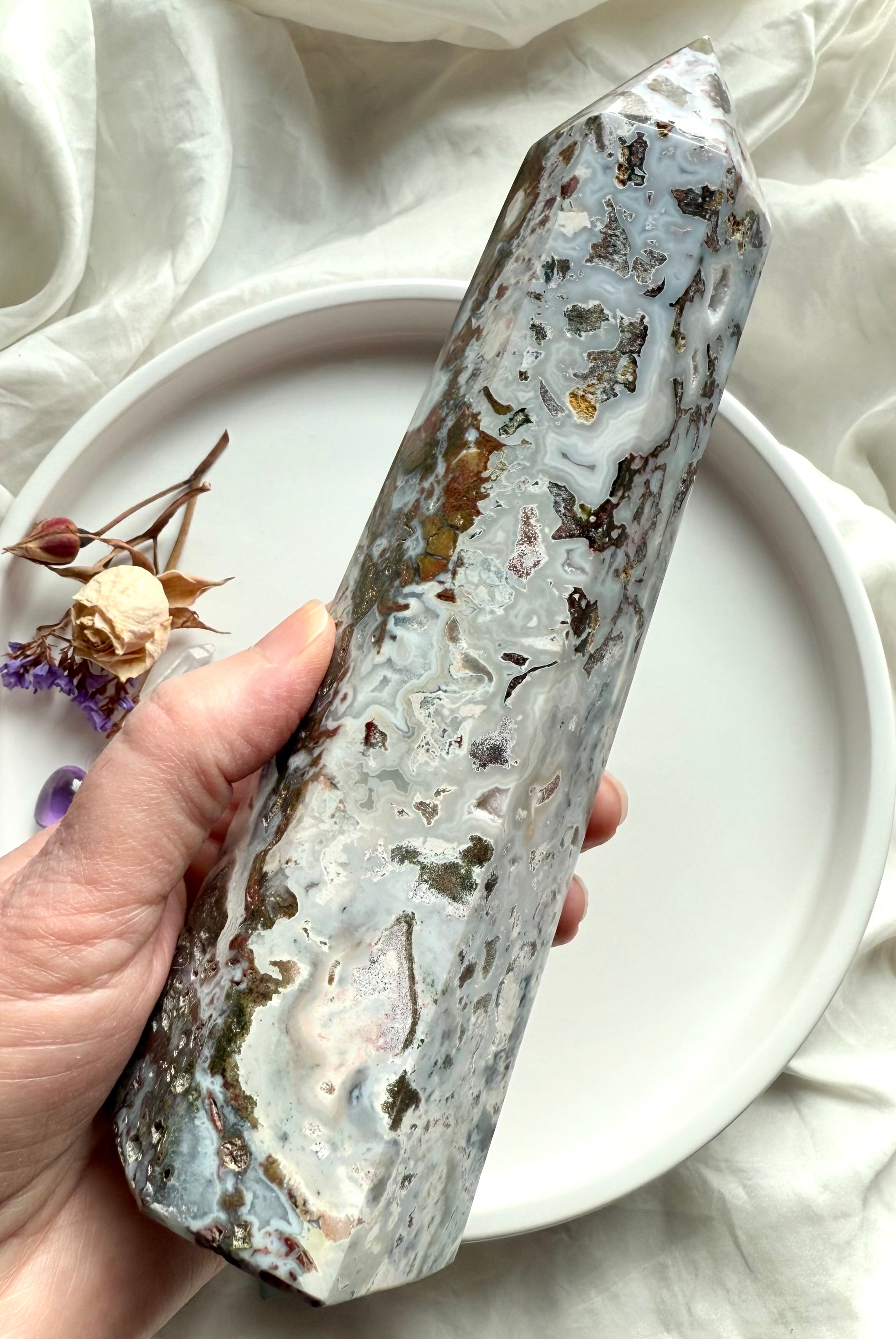 Polished Cosmic Ocean Jasper tower displaying mossy green inclusions, creamy chalcedony swirls, and raw druzy accents