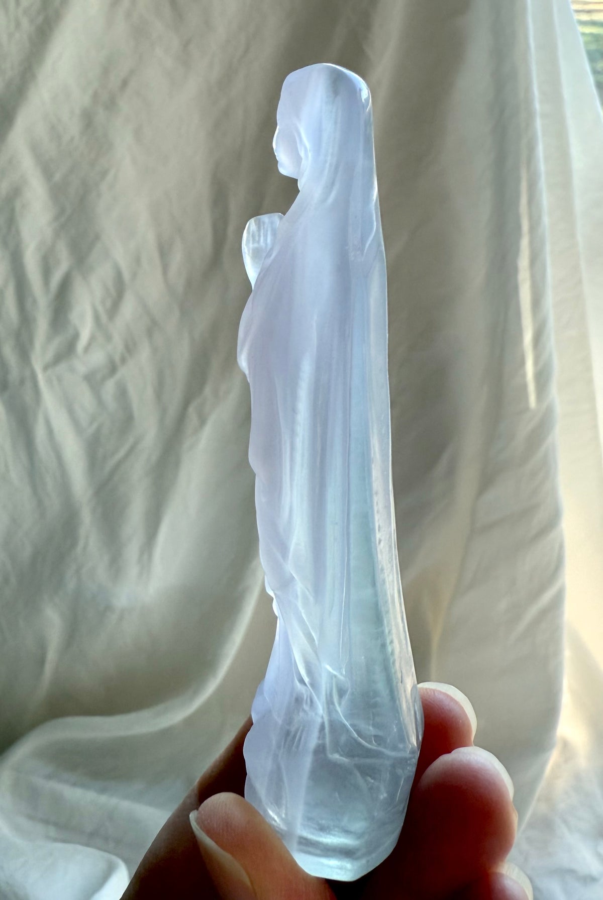 Lavender Fluorite Mother Mary crystal carving with soft green and pale purple tones and subtle natural banding