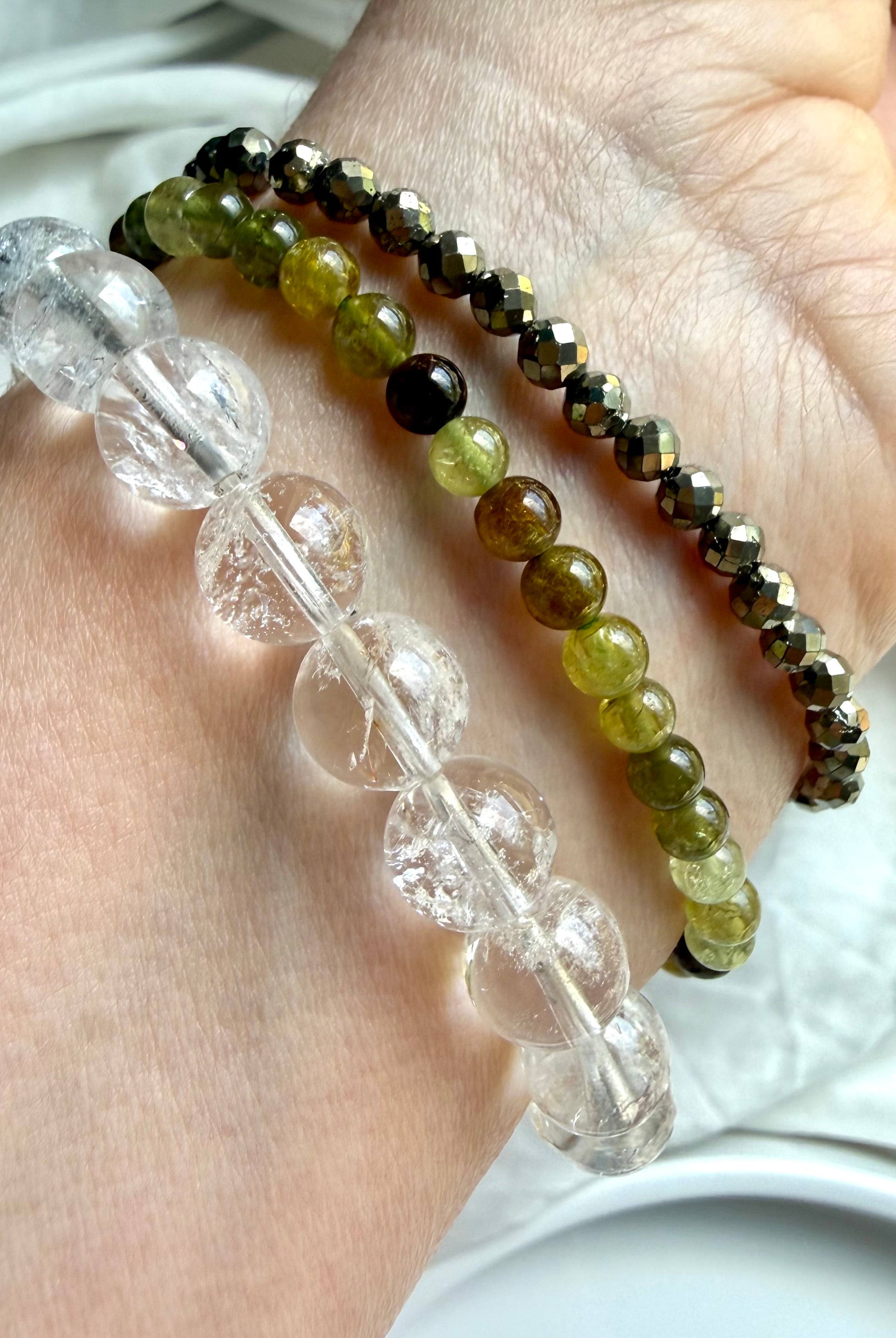 Rainbow Quartz, Tsavorite Garnet, and faceted Pyrite bracelet stack with luminous crystal gemstones and layered luxury styling