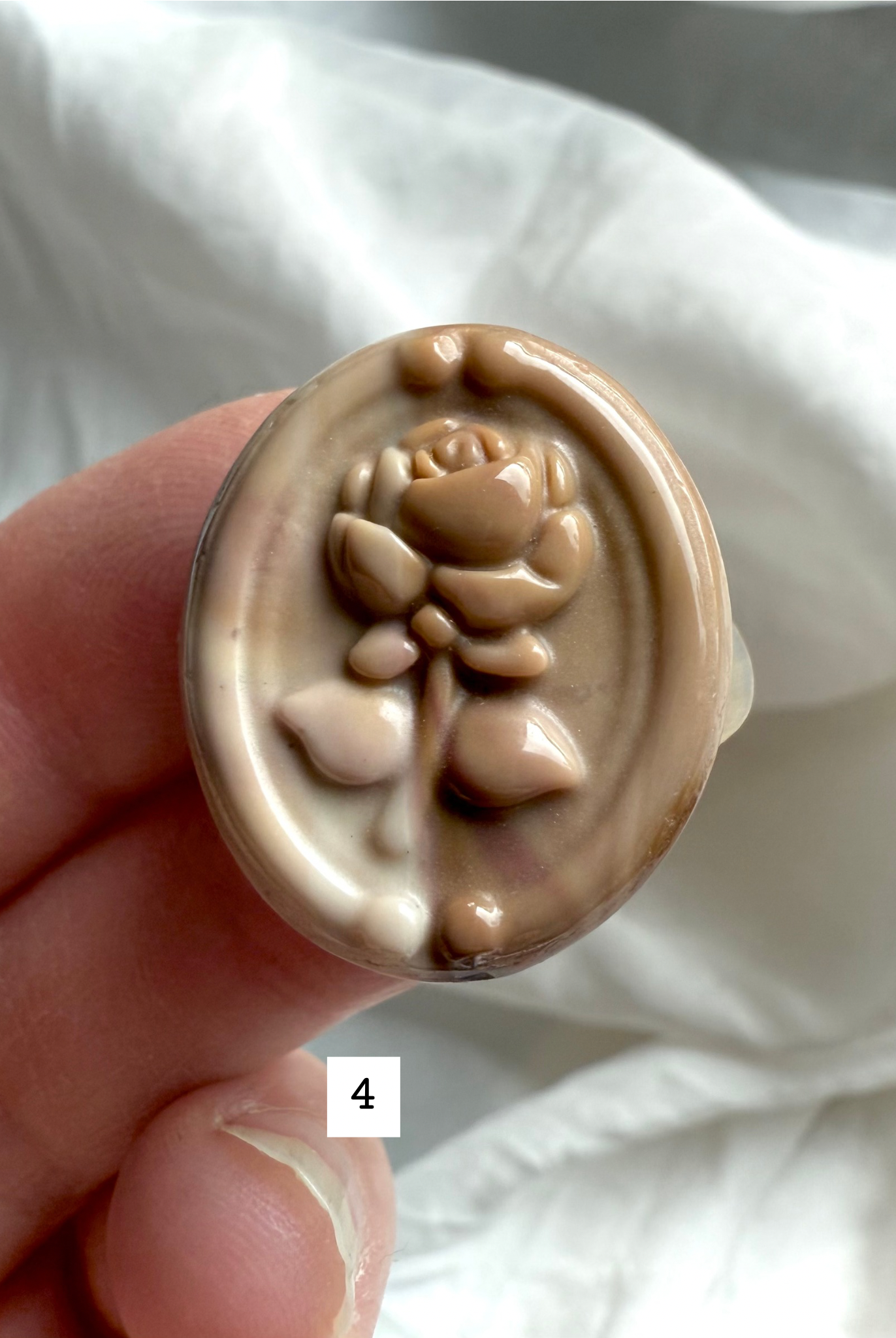 Polychrome Jasper Rose carving #4 in hand with sandy beige and honey-toned patterns