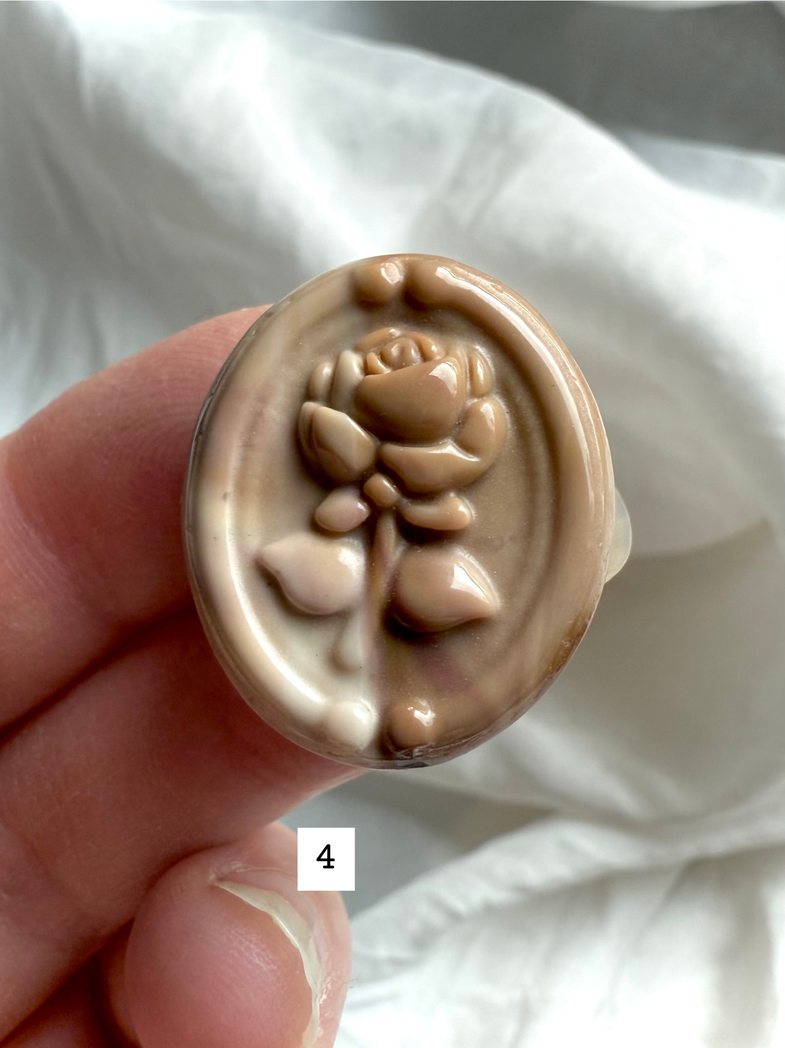 Polychrome Jasper Rose carving #4 in hand with sandy beige and honey-toned patterns