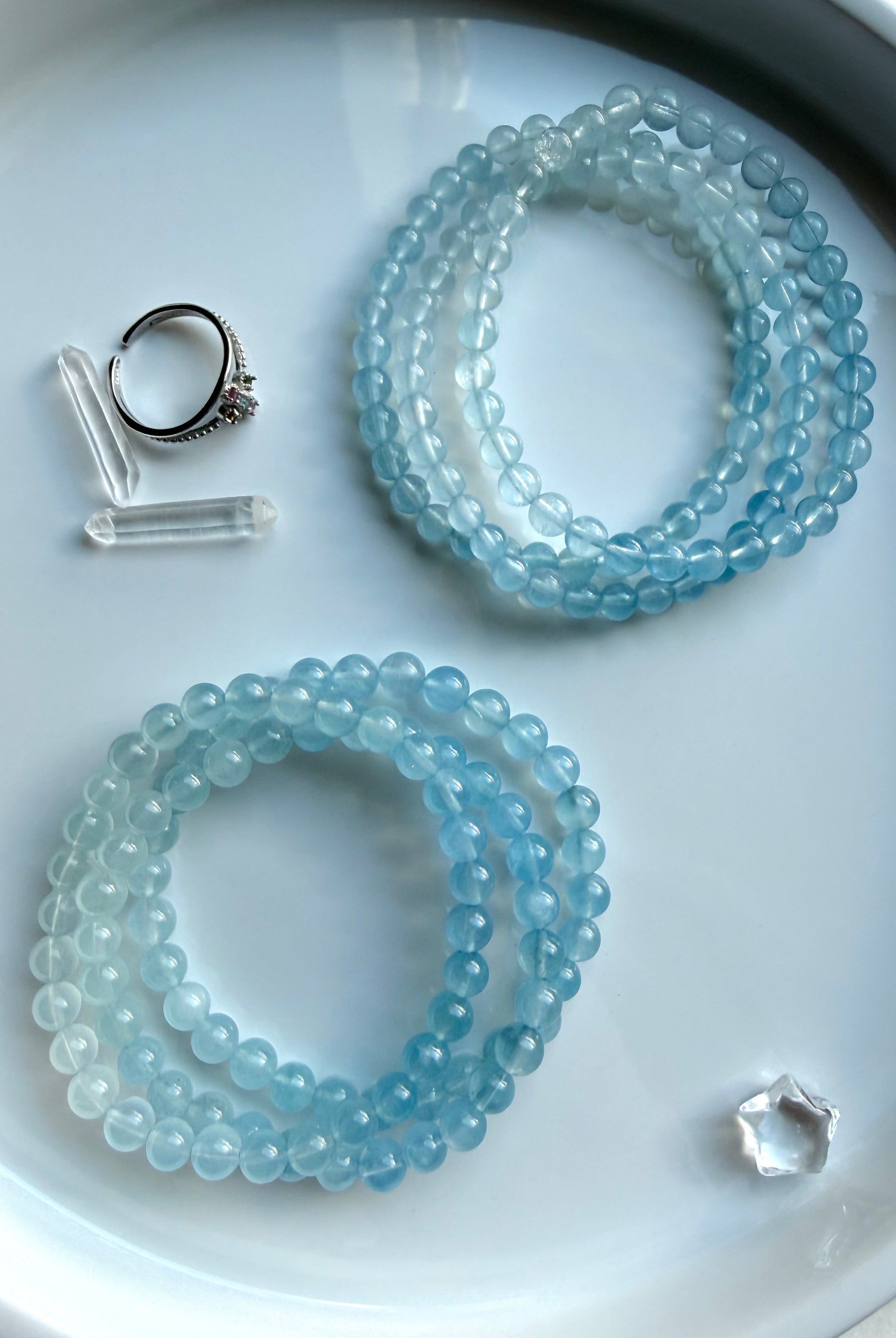 Aquamarine March birthstone bracelets shown in two stacks showing – blue ombré details