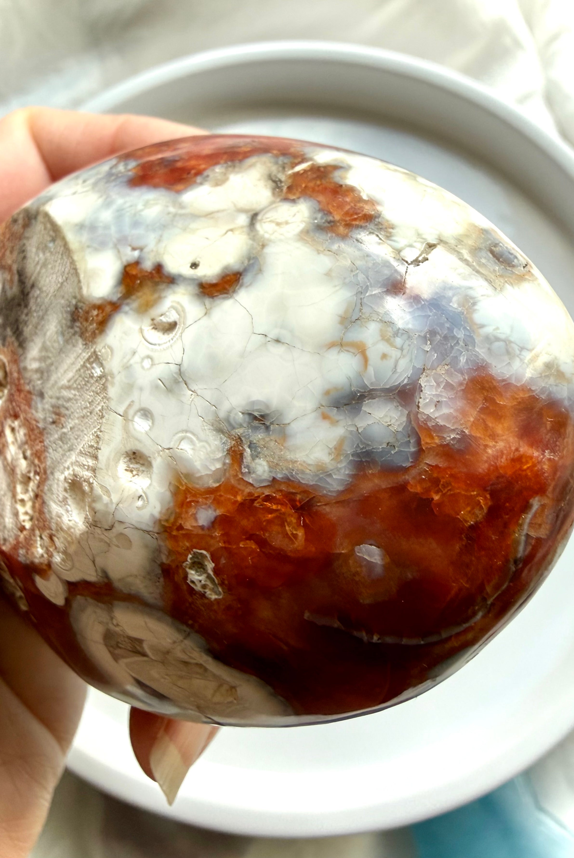 side view of carnelian crystal bowl with layered agate bands and quartz core