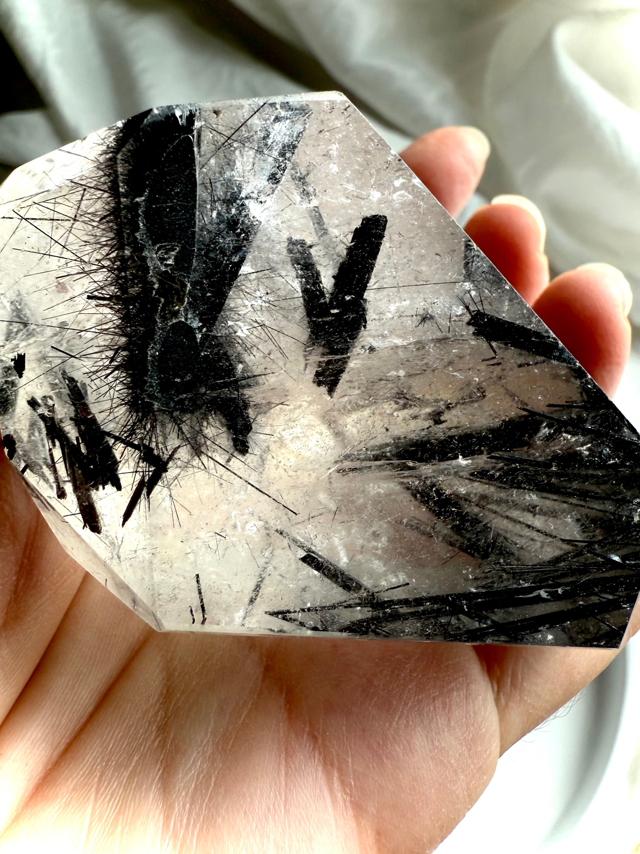 Black Tourmaline in Quartz freeform crystal held in hand, natural protective stone with needle inclusions
