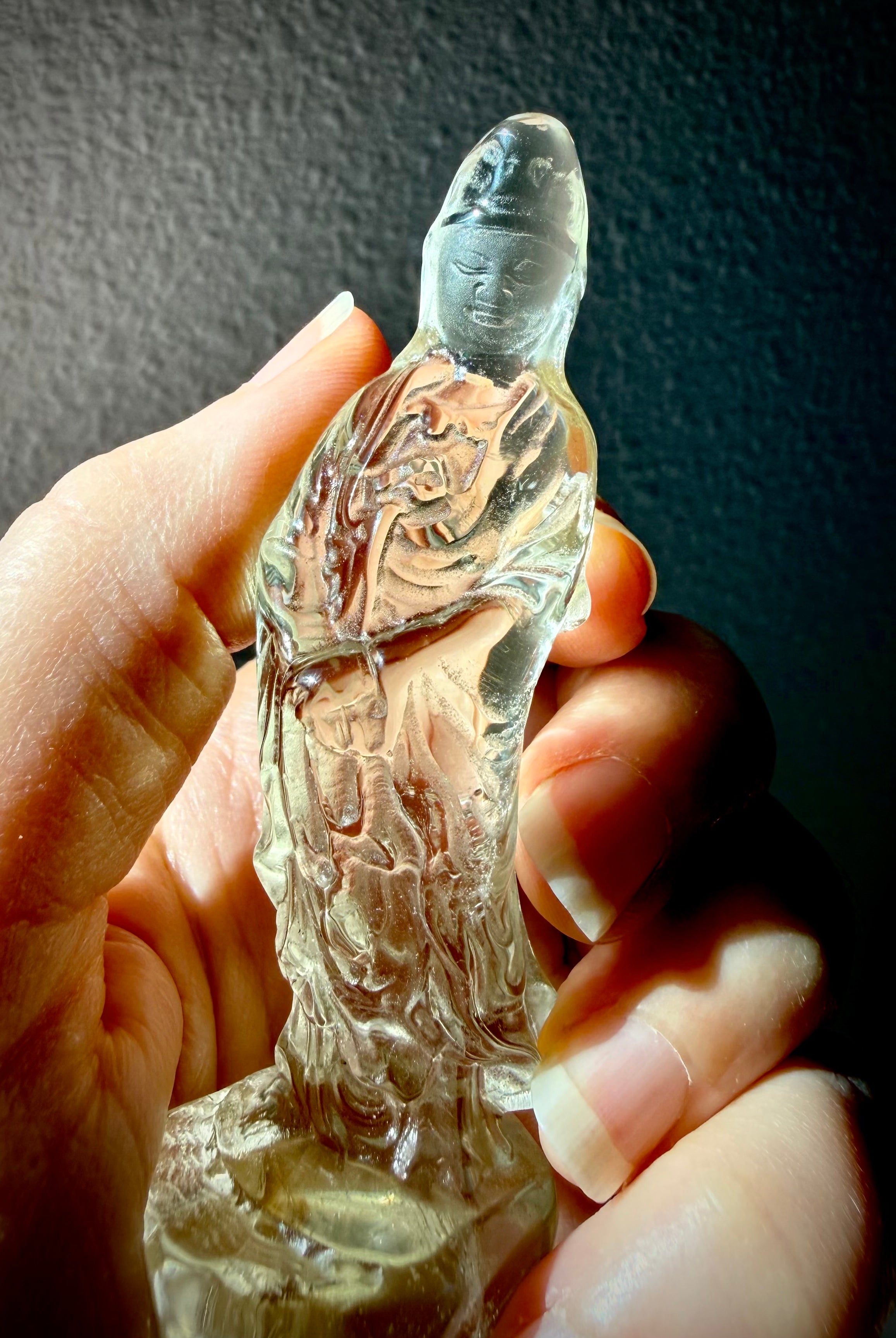 handheld Citrine Quan Yin goddess carving with warm honey tones and polished translucent finish