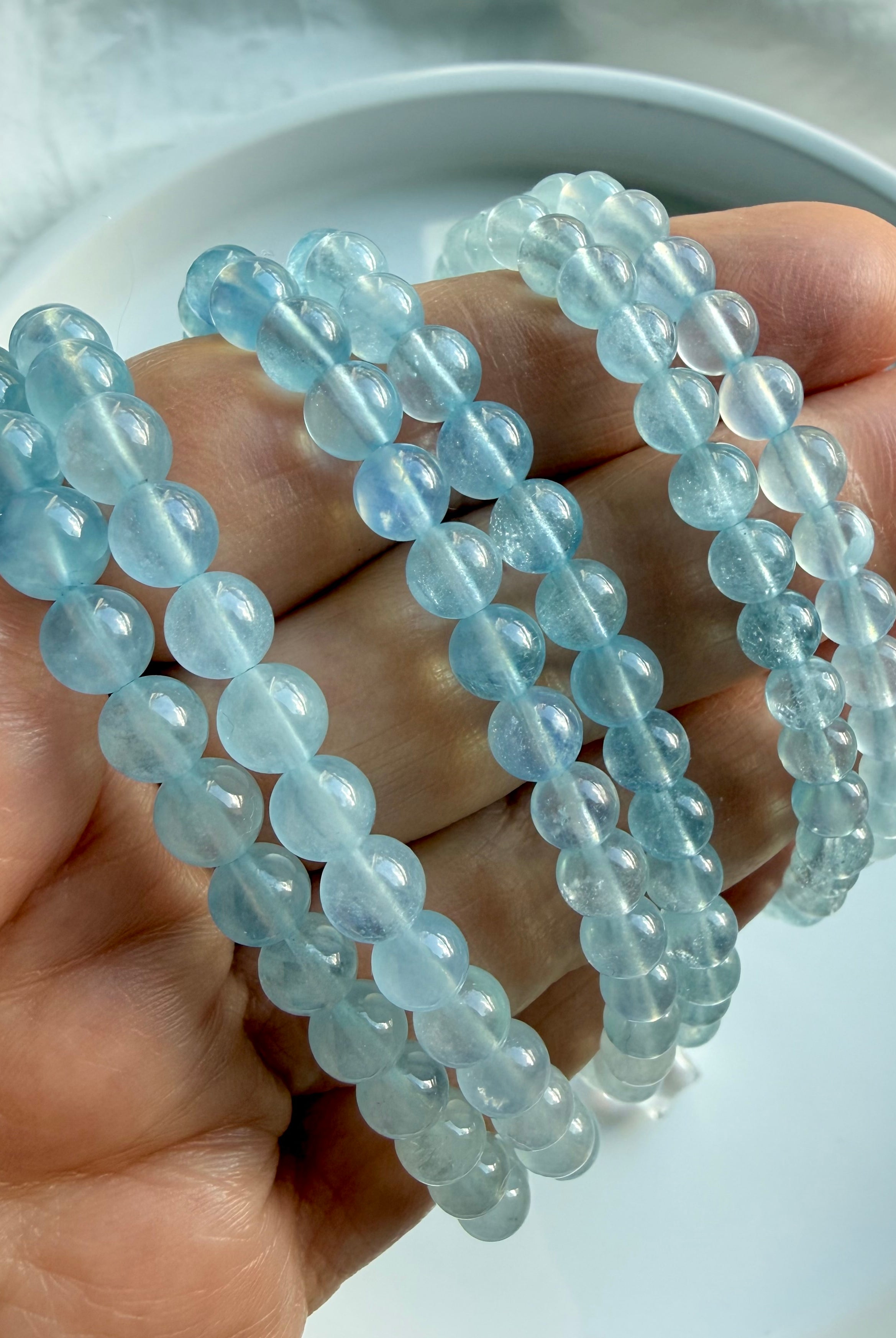 Stacked Aquamarine crystal bracelets in ombré blue tones – March birthstone gemstone jewelry