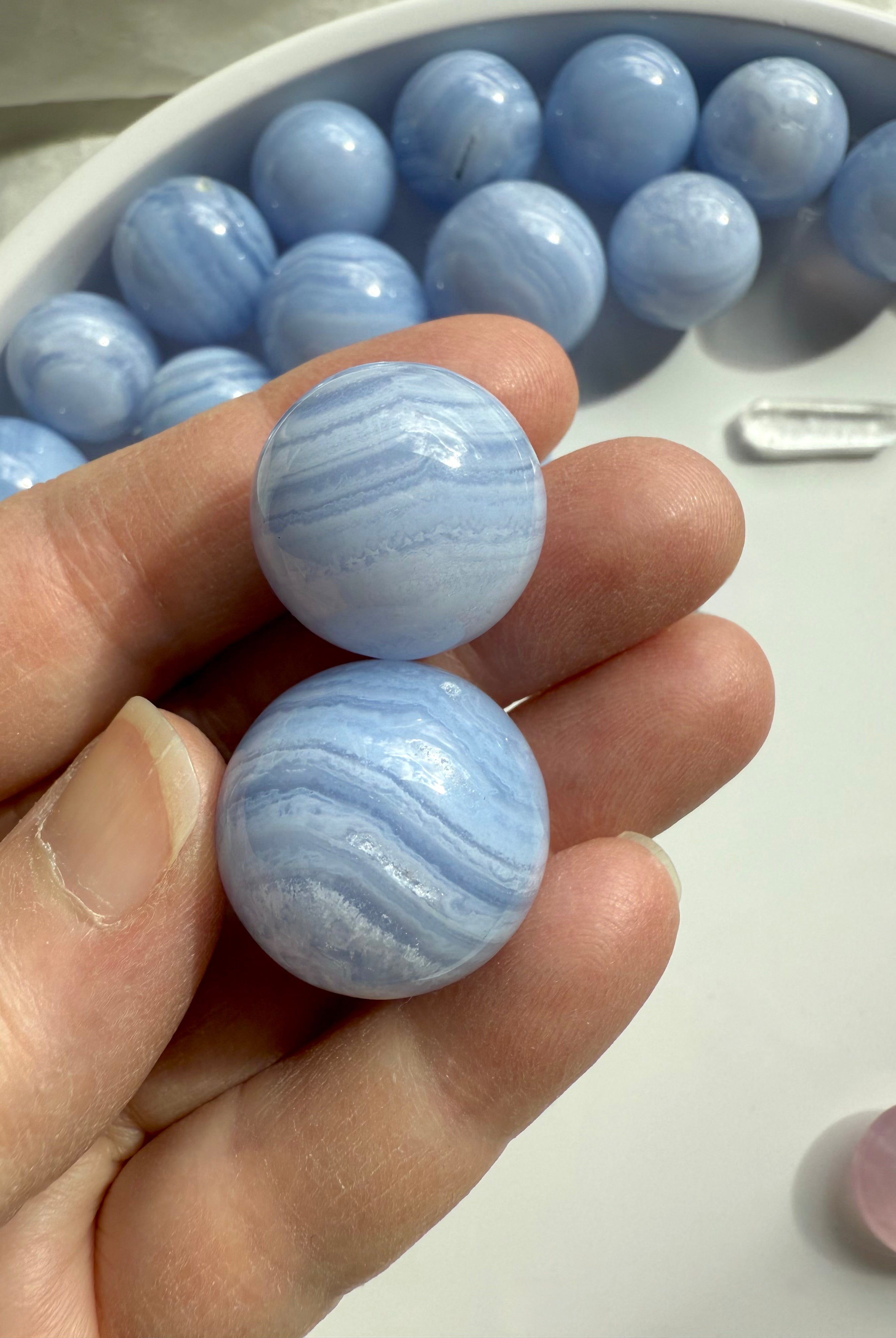 High quality mini Blue Lace Agate Spheres shown on my hand for scale