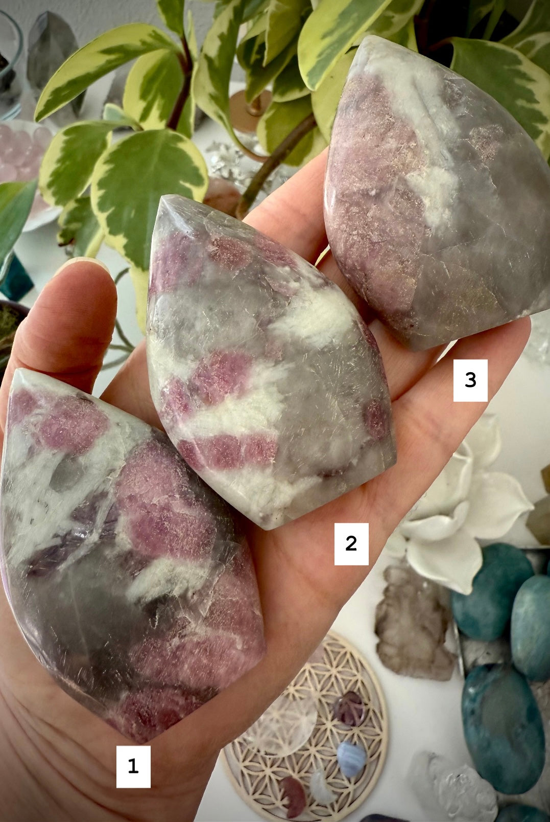 Crystal Flames made of Unicorn Stone — gemstone carvings with pink, purple, and earthy mineral patterns