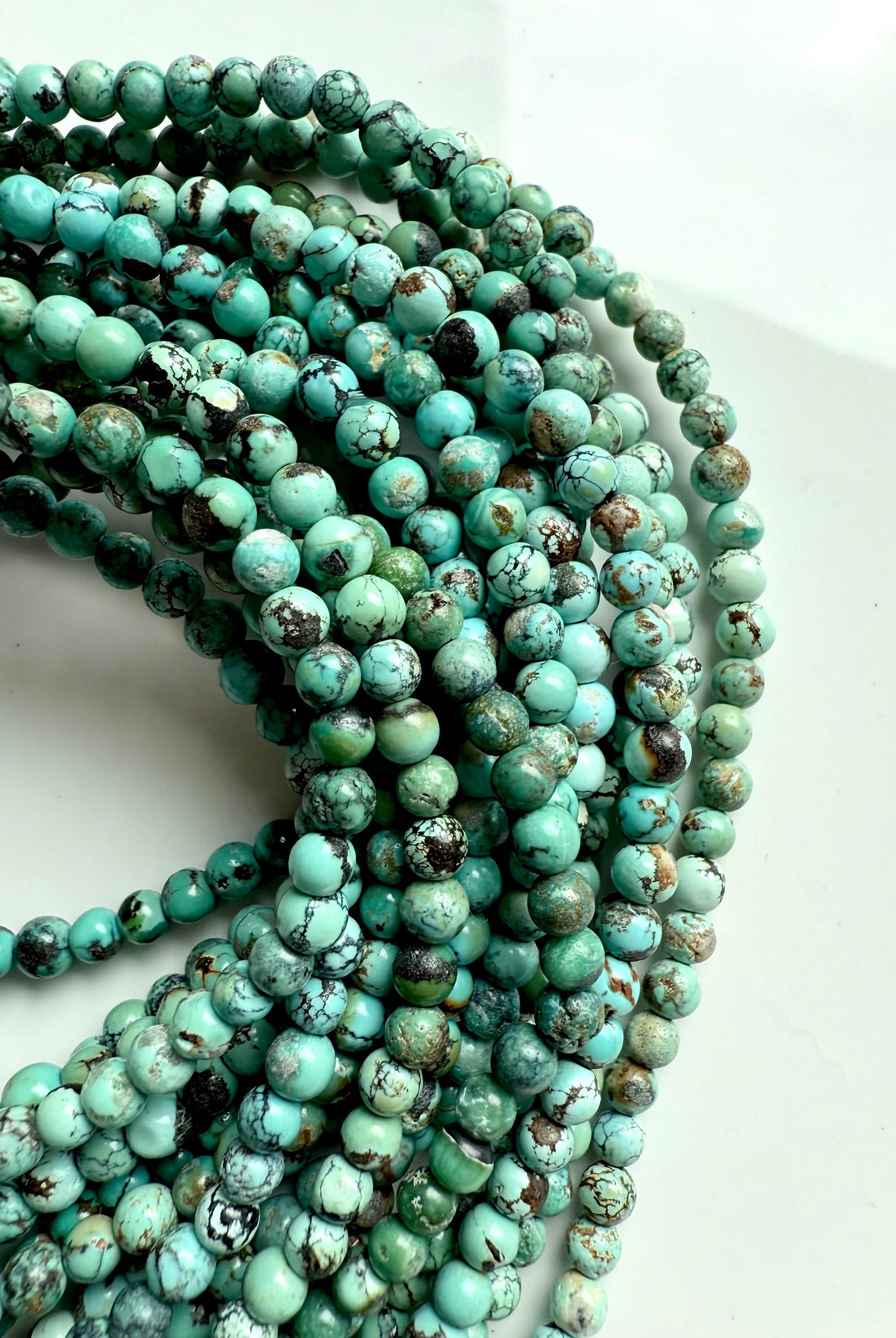 High-quality turquoise bead strands with rich matrix patterns and earthy green-blue tones