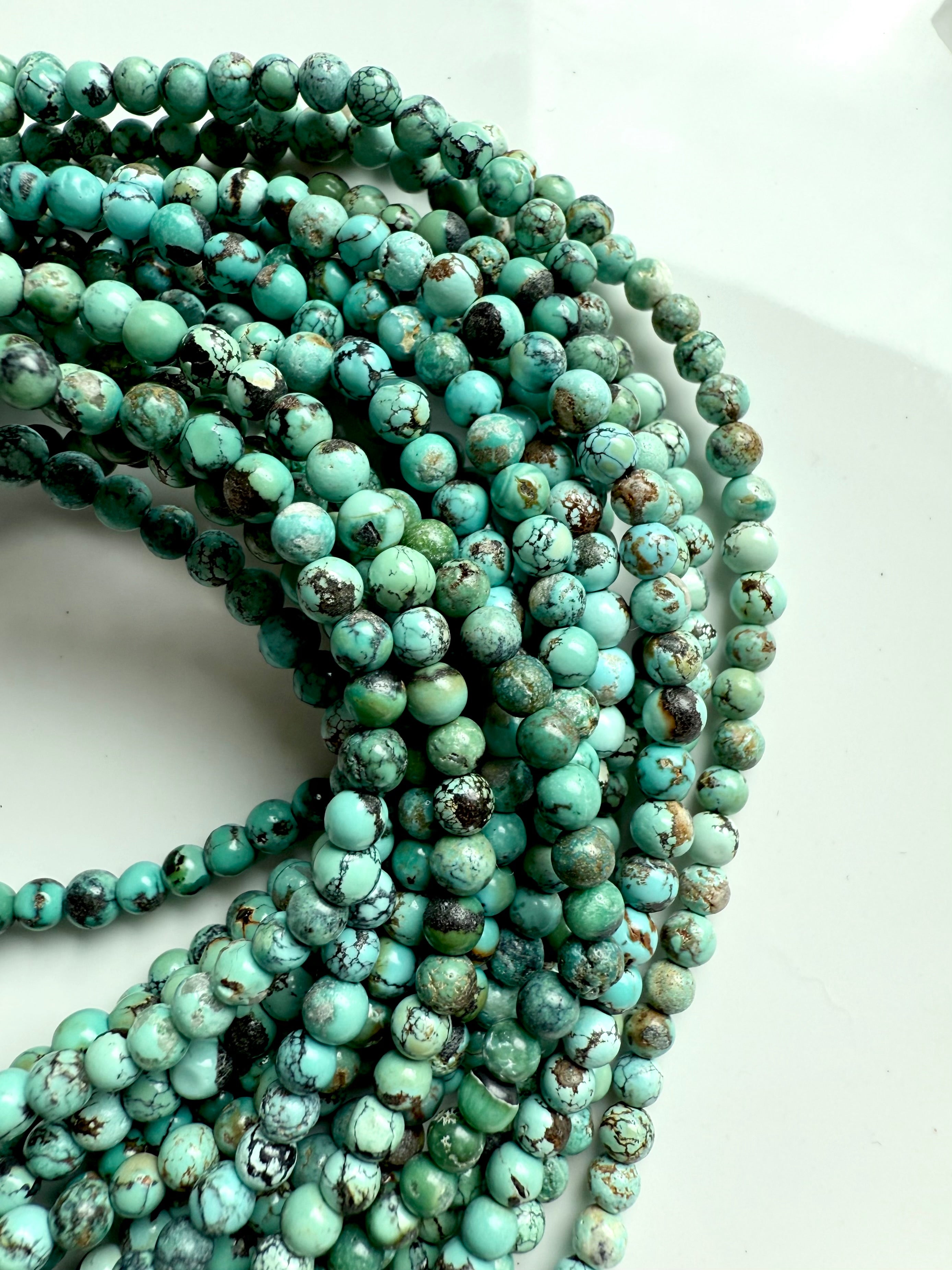 High-quality turquoise bead strands with rich matrix patterns and earthy green-blue tones