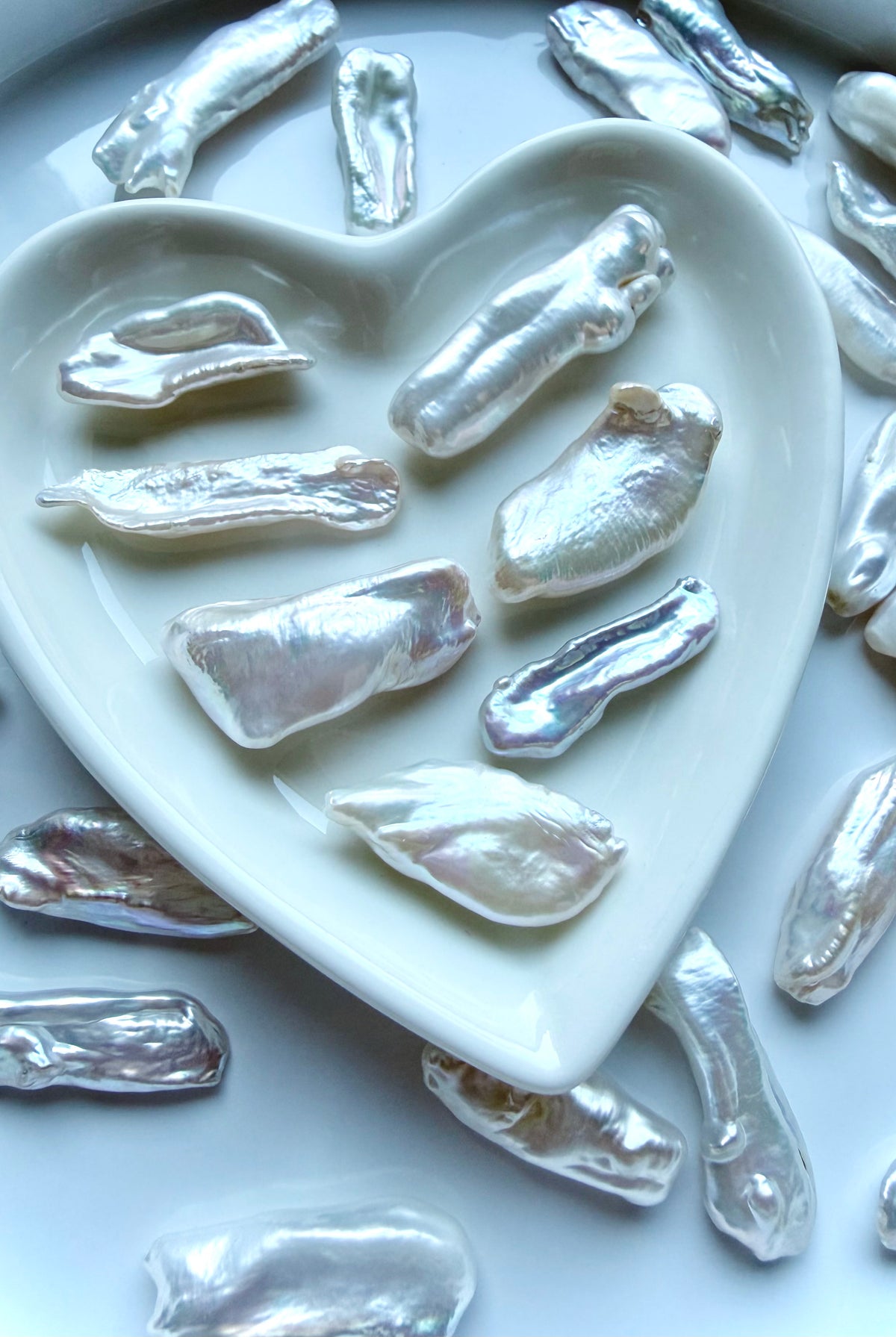 Baroque freshwater stick pearls displayed in heart dish showing luminous nacre and unique natural shapes