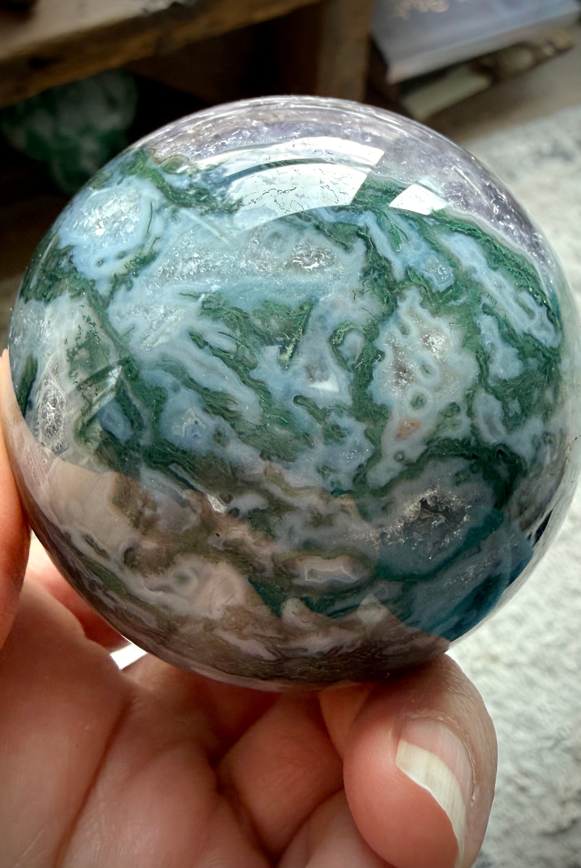 Polished Moss Agate and Amethyst crystal sphere for meditation, display, and sacred spaces