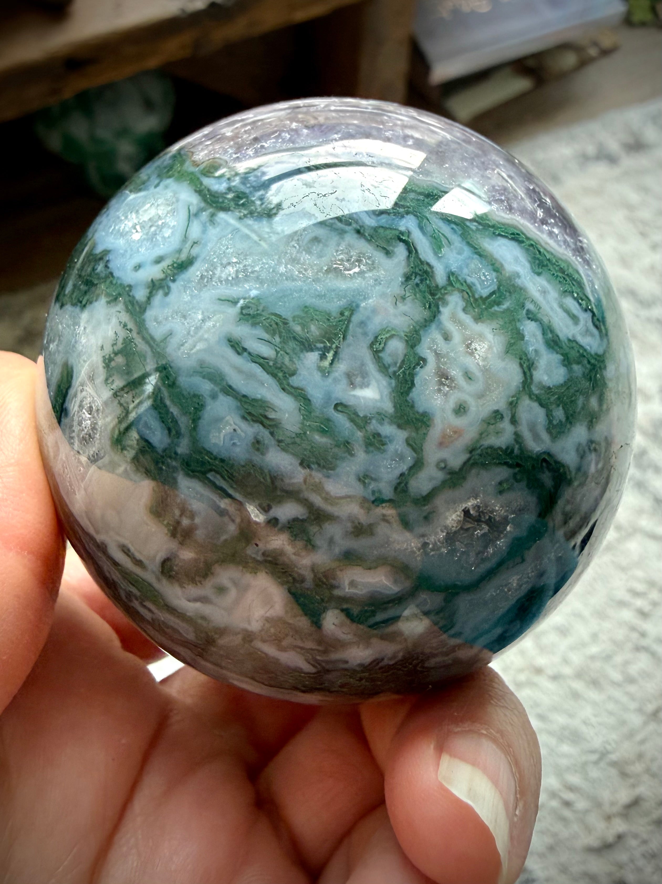 Polished Moss Agate and Amethyst crystal sphere for meditation, display, and sacred spaces