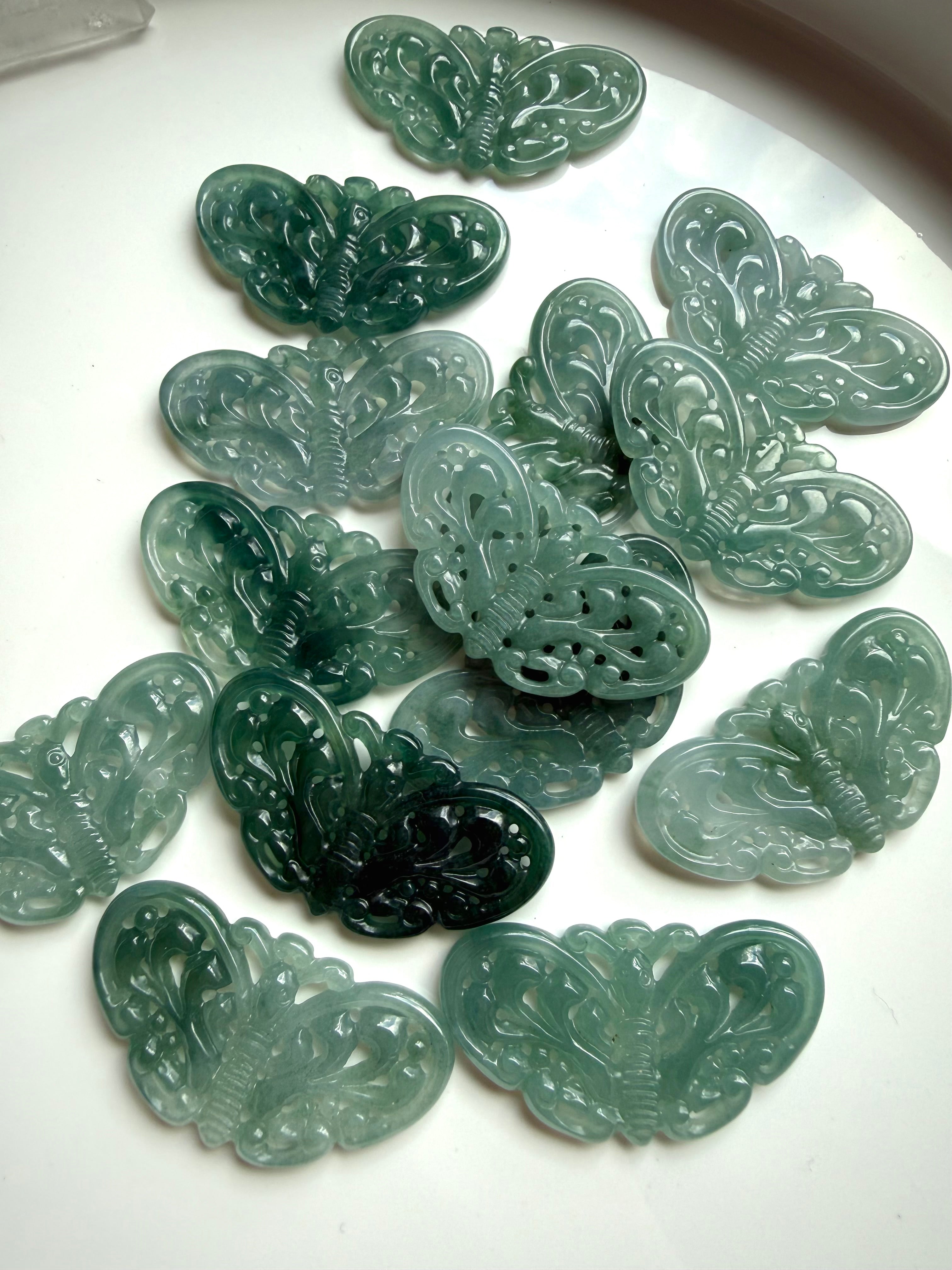 Collection of Blue Water Jade butterfly carvings from Guatemala in varying shades of teal jade