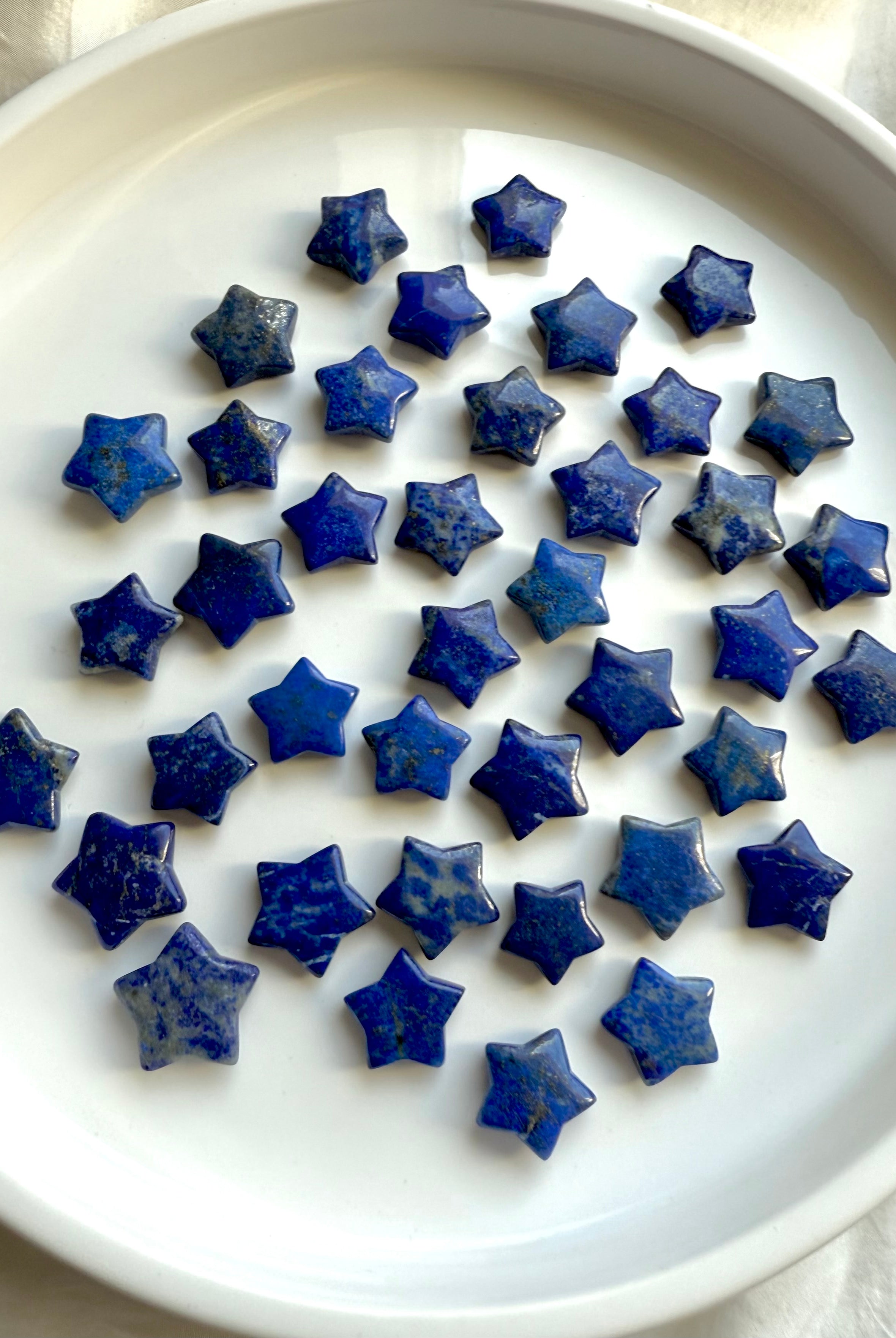 Multiple Mini Lapis Lazuli star crystals on white background