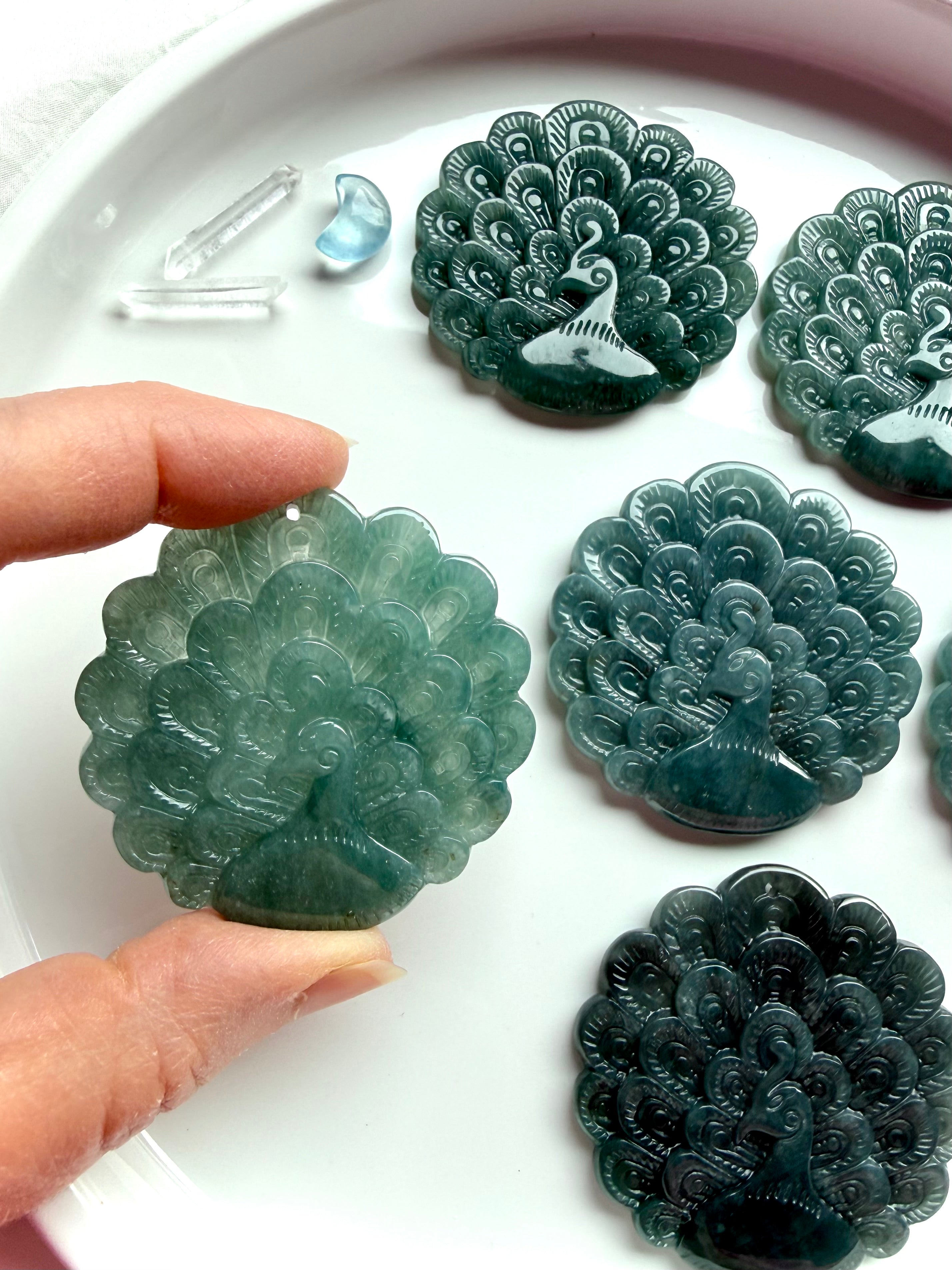 Blue Water Jade peacock medallions with detailed double-sided carvings in natural Guatemalan jade