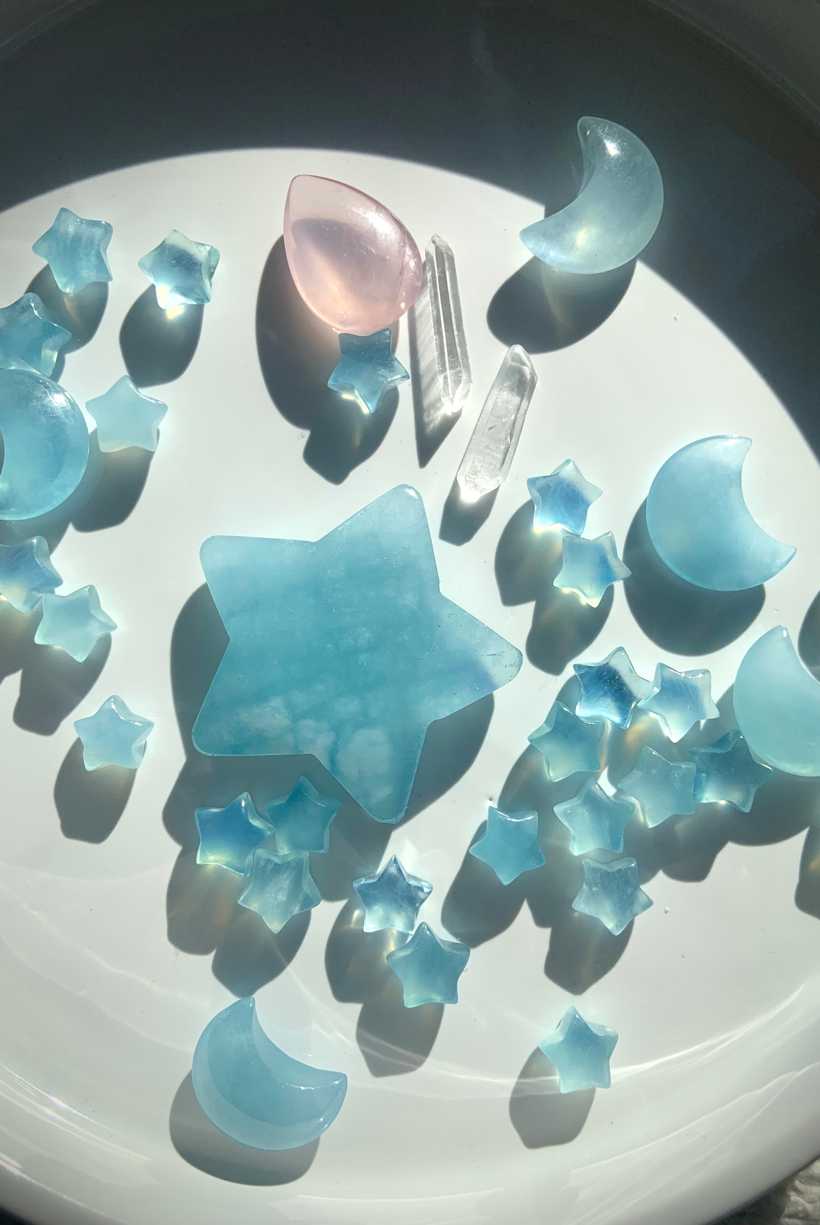 Luminous blue Aquamarine crystal carvings reflecting natural light