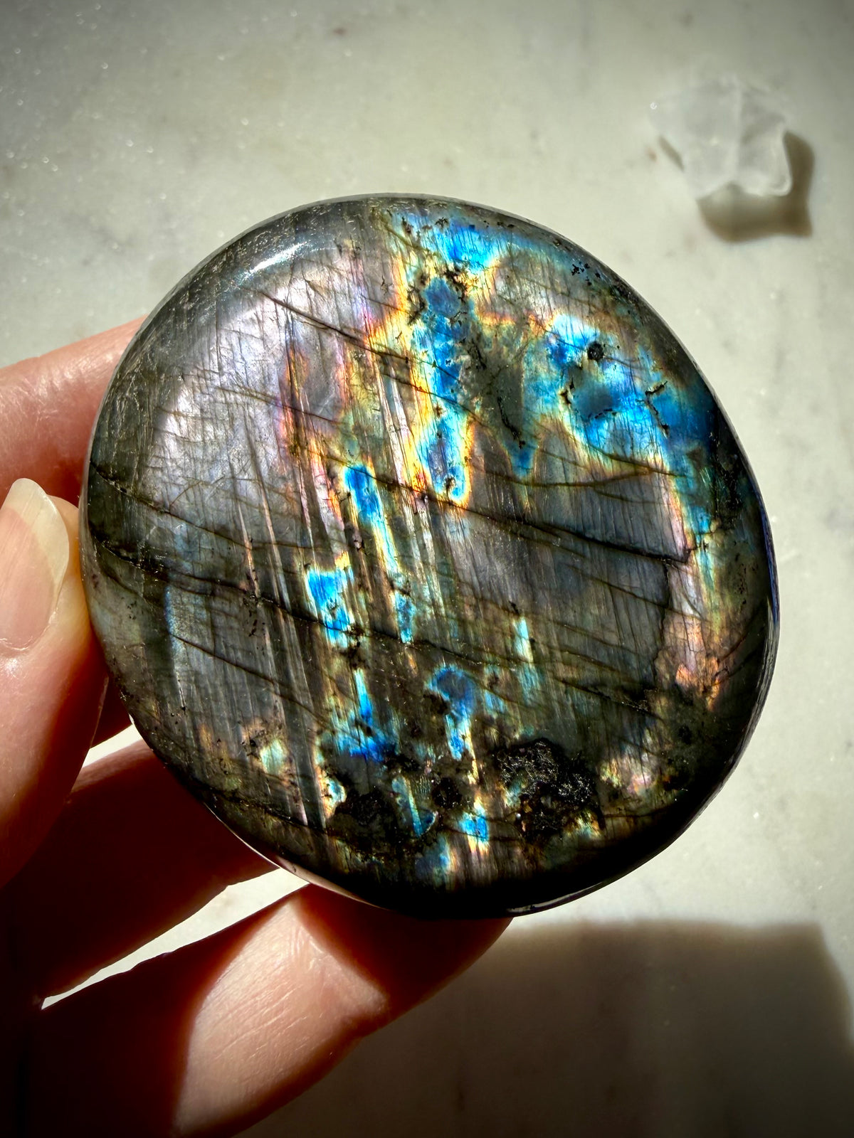 Rainbow Labradorite crystal showing purple, aqua, electric blue and golden flash across the polished surface