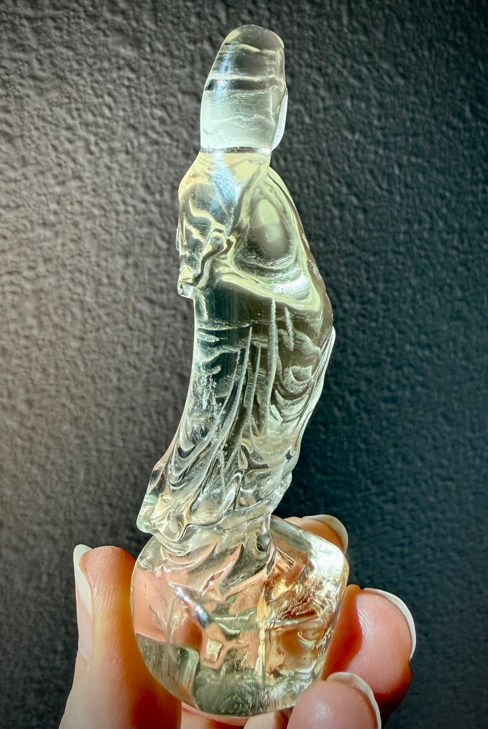 rear view of natural Citrine Quan Yin statue highlighting carved robe details and crystal clarity