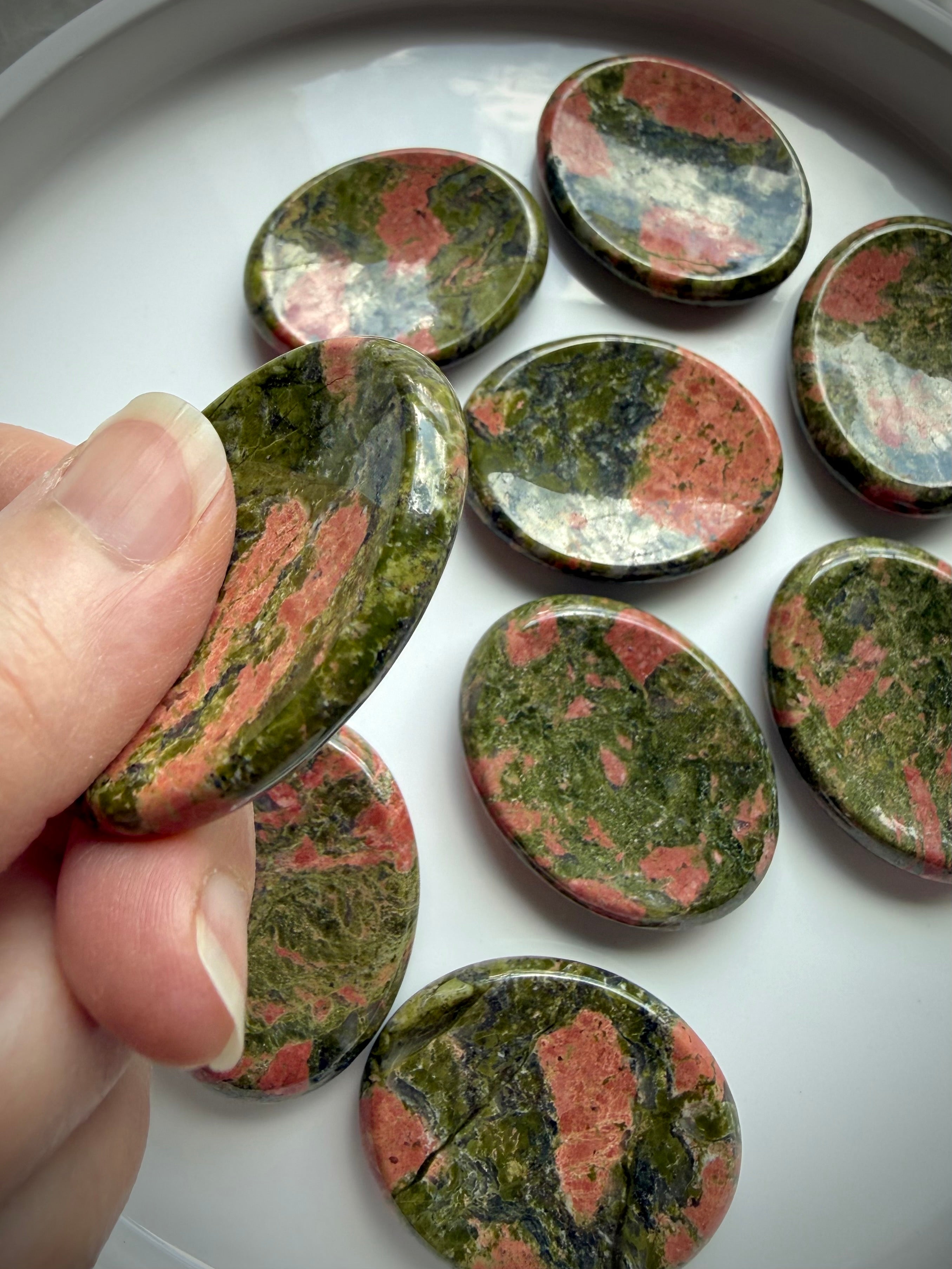 unakite worry stones in hand for stress relief grounding and emotional support