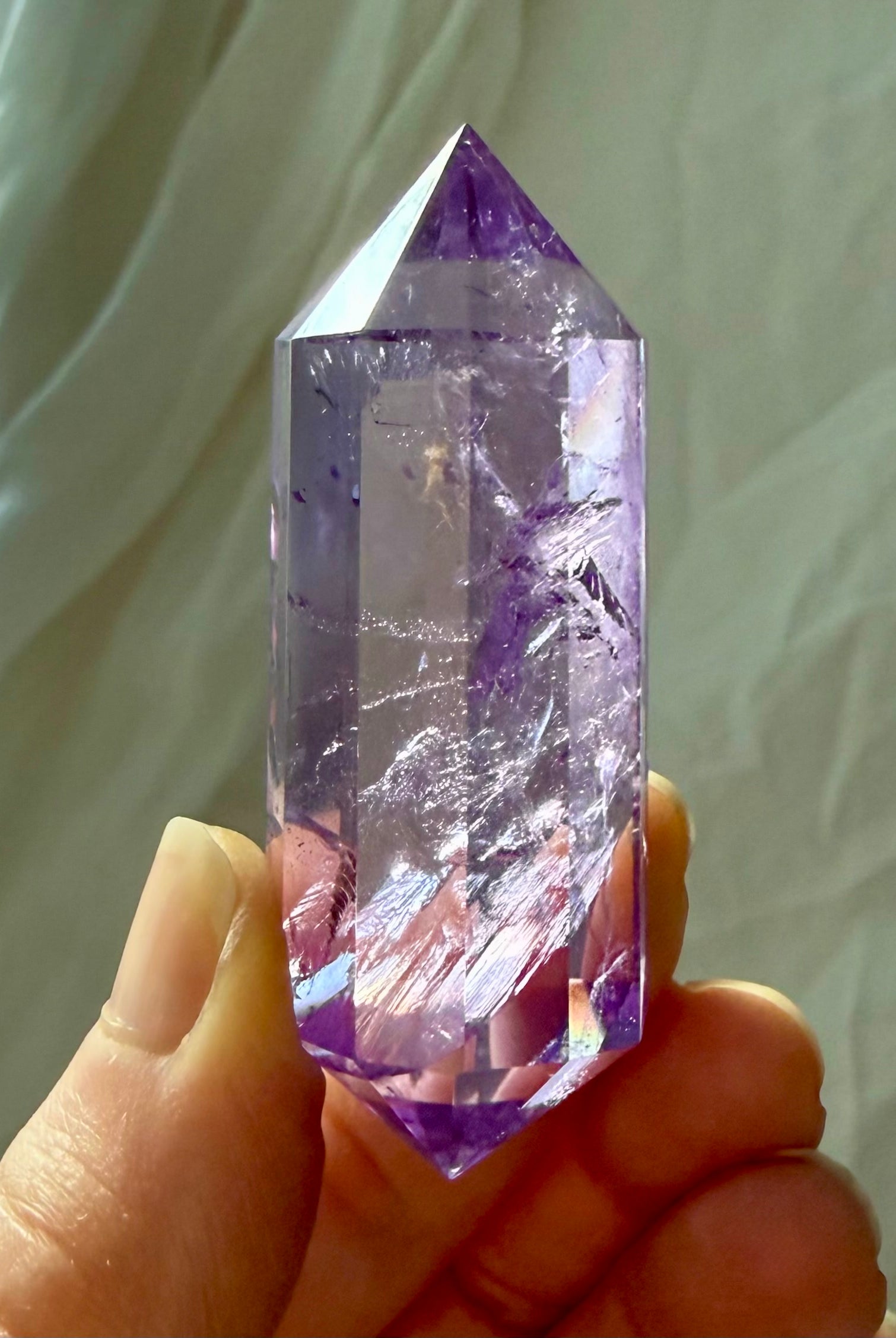 Faceted Amethyst Vogel crystal wand from Brazil with rainbow inclusions and luminous color