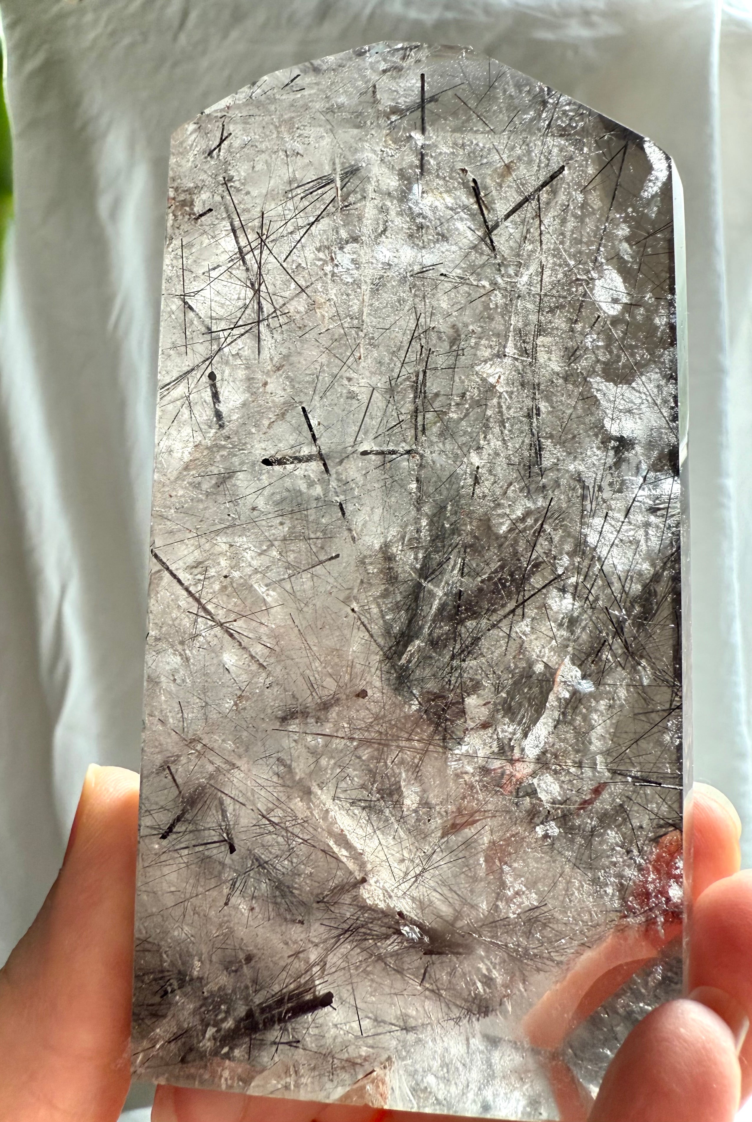 Close detail of Black Tourmaline inclusions and rainbow flash inside natural Quartz crystal