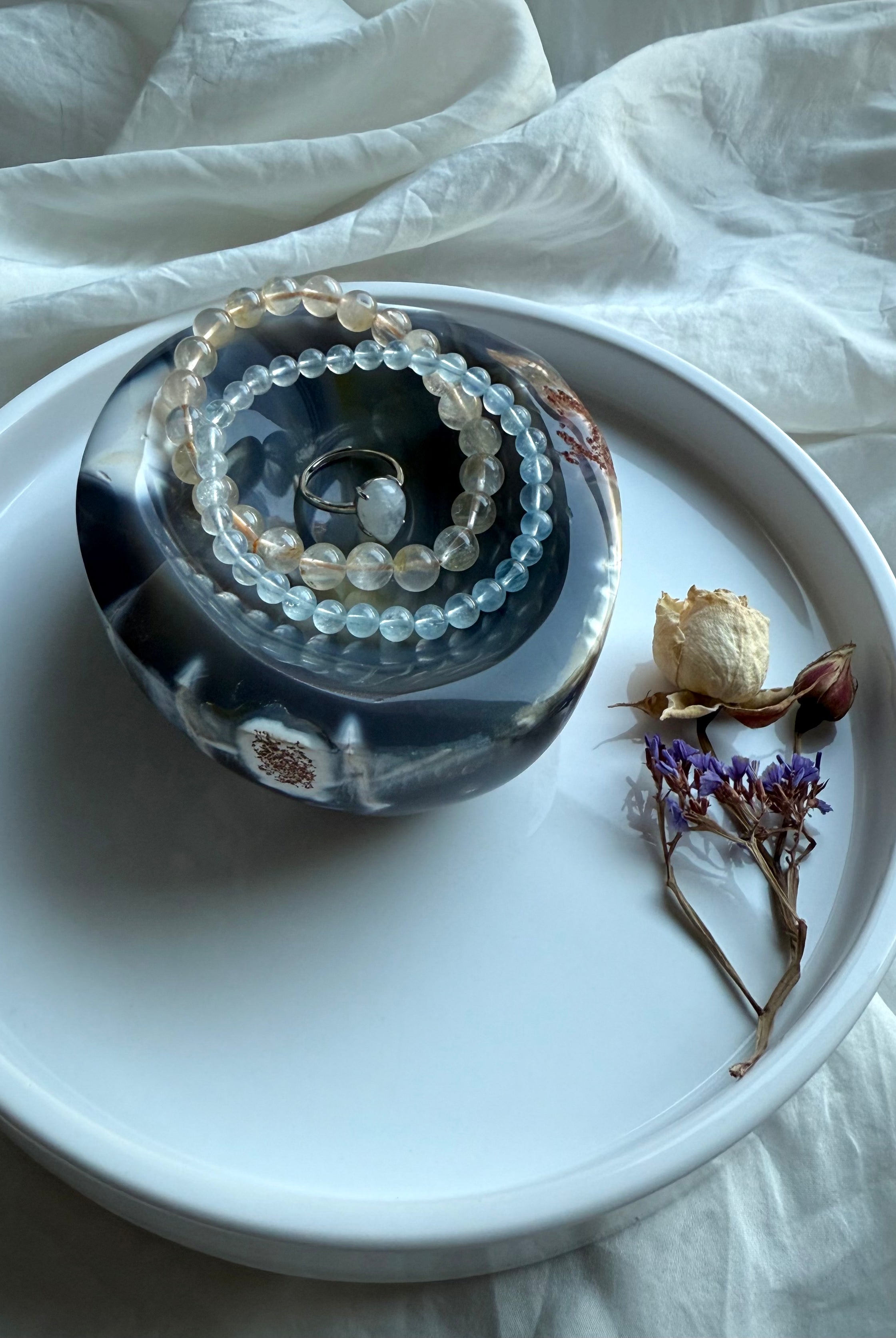 Orca Agate offering bowl styled with gemstone bracelets and a ring — hand-carved crystal dish for jewelry, offerings, and sacred altar display.