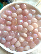 Angel Aura Rose Quartz Tumbles shown on a white plate.